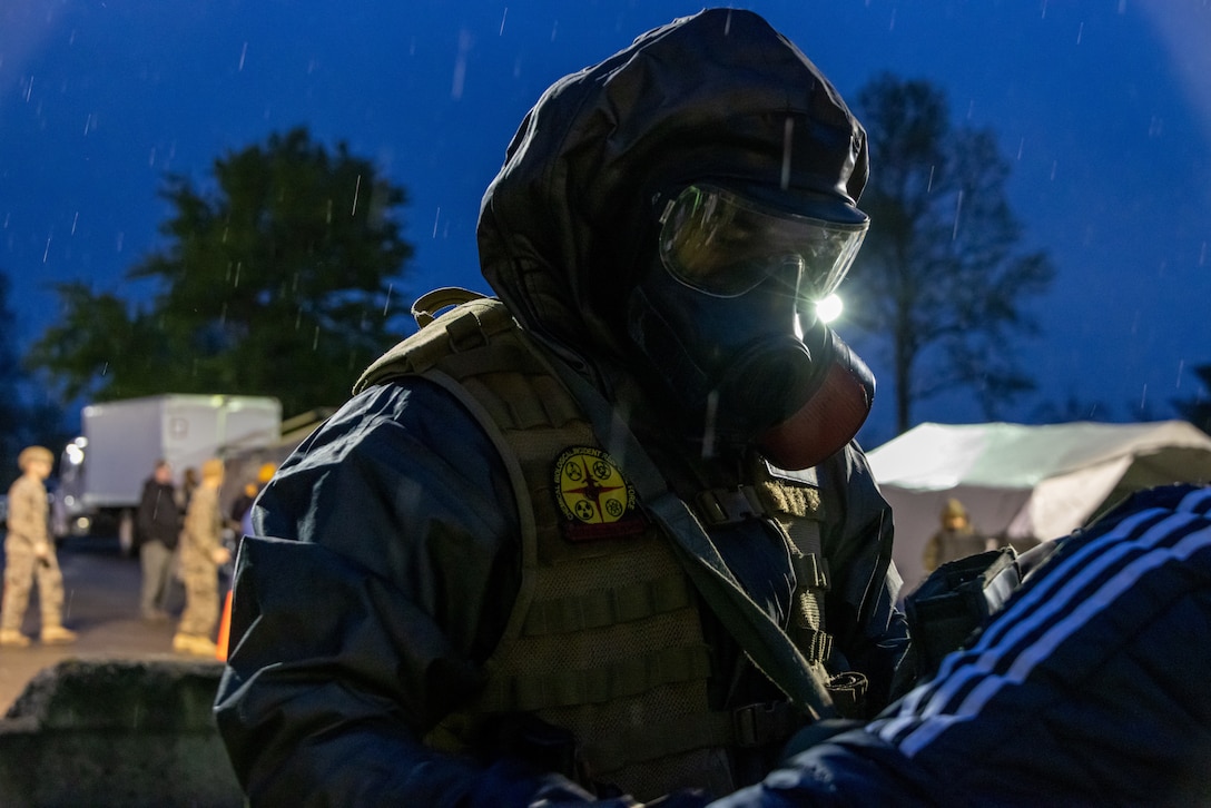 A U.S. Marines with the Chemical Biological Incident Response Force scans a simulated casualty for chemical particulates and radiation in the decontamination line during Exercise Guardian Response 2023 at the Muscatatuck Urban Training Center, Indiana, May 1, 2023. Exercise Guardian Response is an annual exercise that provides realistic training in a multi-domain environment, allowing units to exercise their pre-mobilization and pre-deployment capabilities to maintain readiness for chemical, biological, radiological, nuclear, or explosive disasters. (U.S. Marine Corps photo by Staff Sgt. Jacqueline A. Clifford)