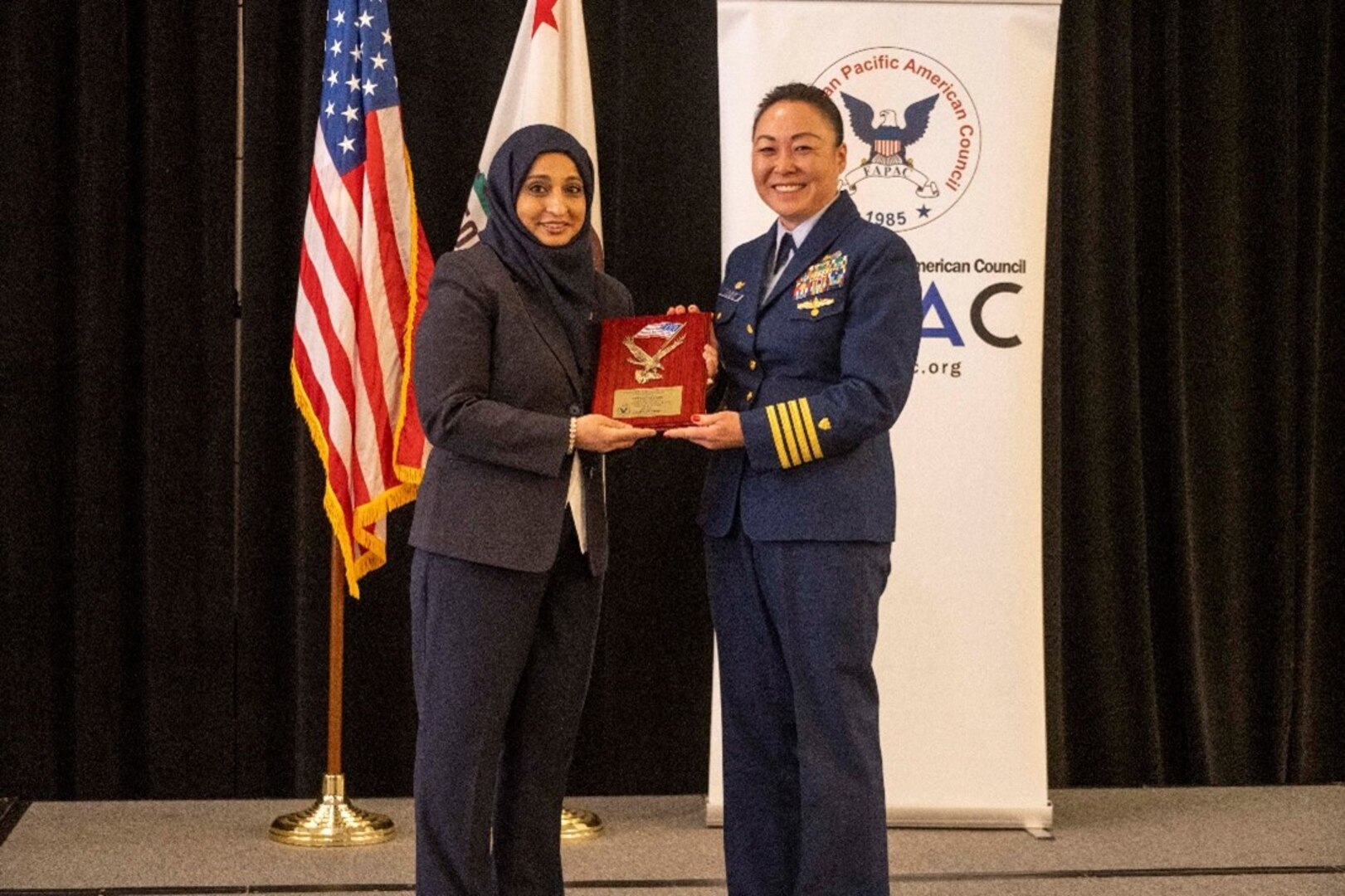 Capt. Eva Van Camp receives the 2023 Federal Asian Pacific American Council (FAPAC) Uniformed Services Award for the Coast Guard from FAPAC President, Fahmida Chhipa, during FAPAC’s 38th National Leadership Training Program, May 10, 2023, Long Beach, CA.