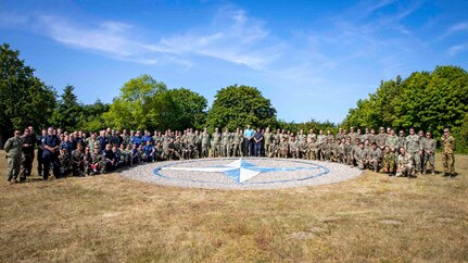 PUTLOS, Germany (June 5, 2023) Service members from NATO Allied nations participating in Exercise Baltic Operations (BALTOPS) 23 pose for a photograph at the Bundeswehr military training area in Putlos, Germany. BALTOPS 23 is the premier maritime-focused exercise in the Baltic Region. The exercise, led by U.S. Naval Forces Europe-Africa, and executed by Naval Striking and Support Forces NATO, provides a unique training opportunity to strengthen combined response capabilities critical to preserving freedom of navigation and security in the Baltic Sea. (U.S Navy photo by Mass Communication Specialist 1st Class Matthew Fink)