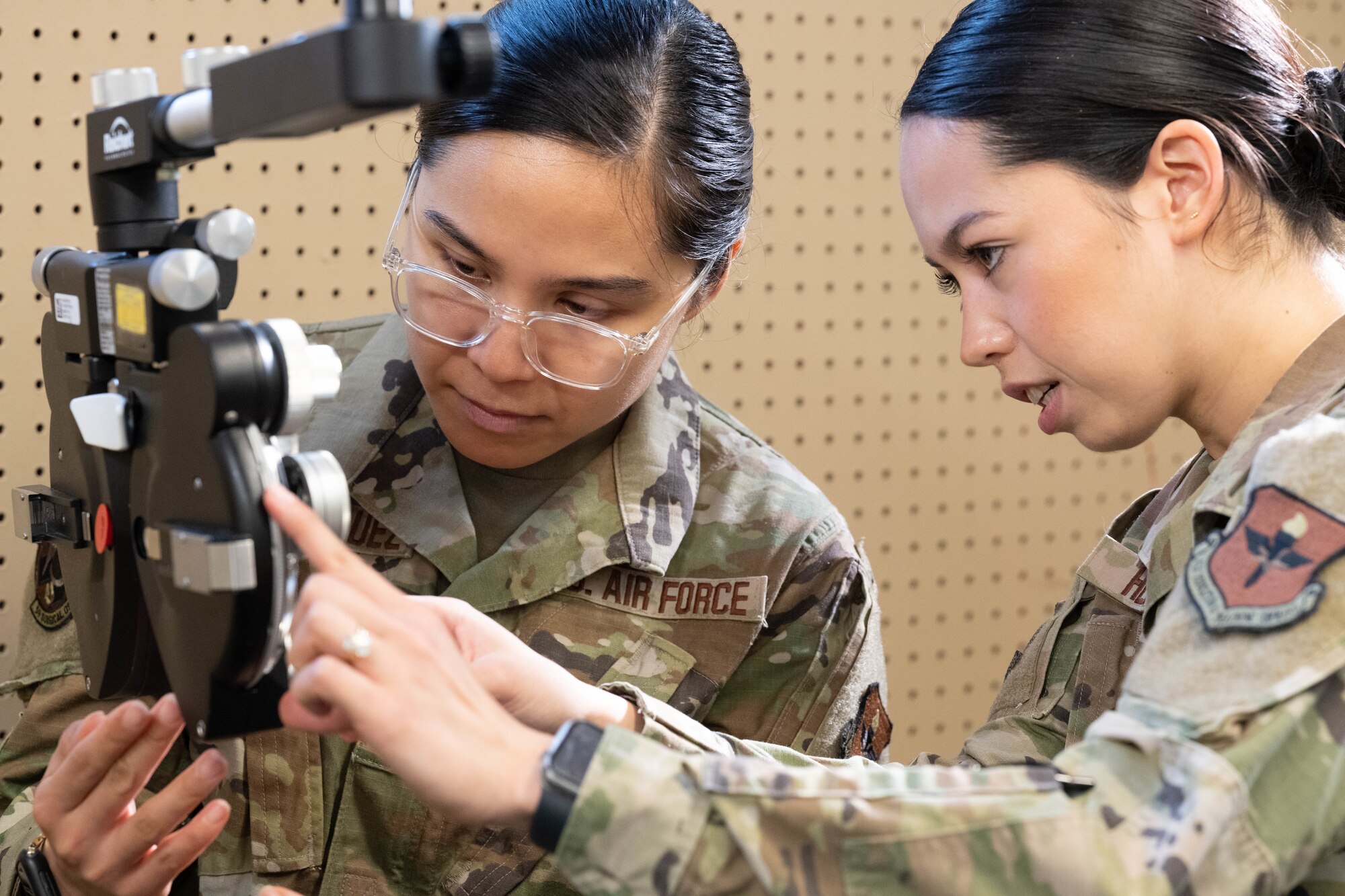 Senior Airman Blessed Velasquez, left, and Airman 1st Class Samantha Heaton, right, both optometry technicians at Joint Base San Antonio, set up a horopter at the Terre Haute Boys and Girls Club in Terre Haute, Ind., June 6, 2023. Service members from across the globe are participating in an Innovative Readiness Training mission called IRT Hoosier Care that provides no-cost medical, dental and vision services to the public.