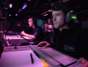 Sailors stand watch in the combat information center aboar USS Antietam (CG 54) in the East China Sea.