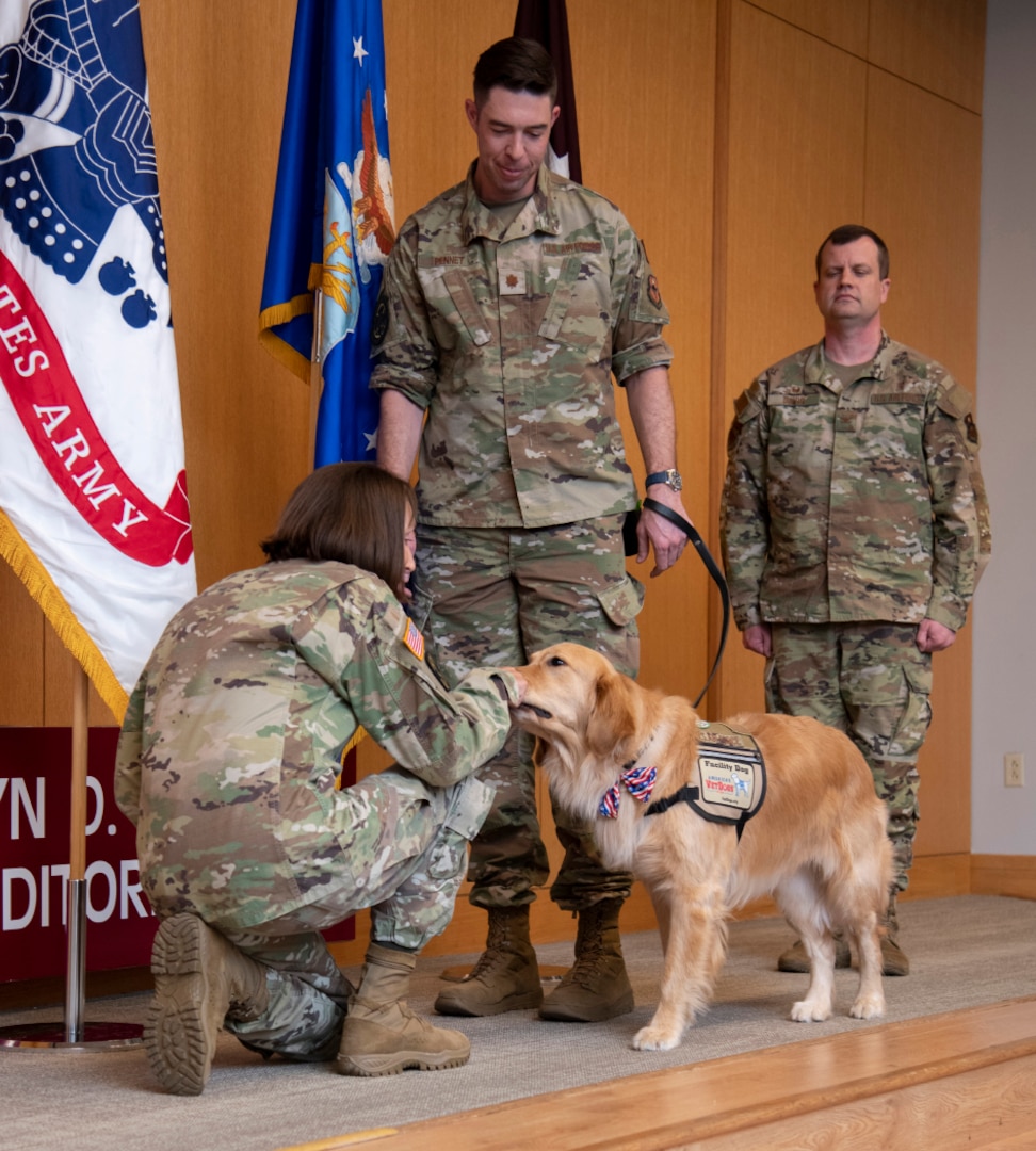 Newly pinned Air Force major accepts his duty with nose bop, paw salute