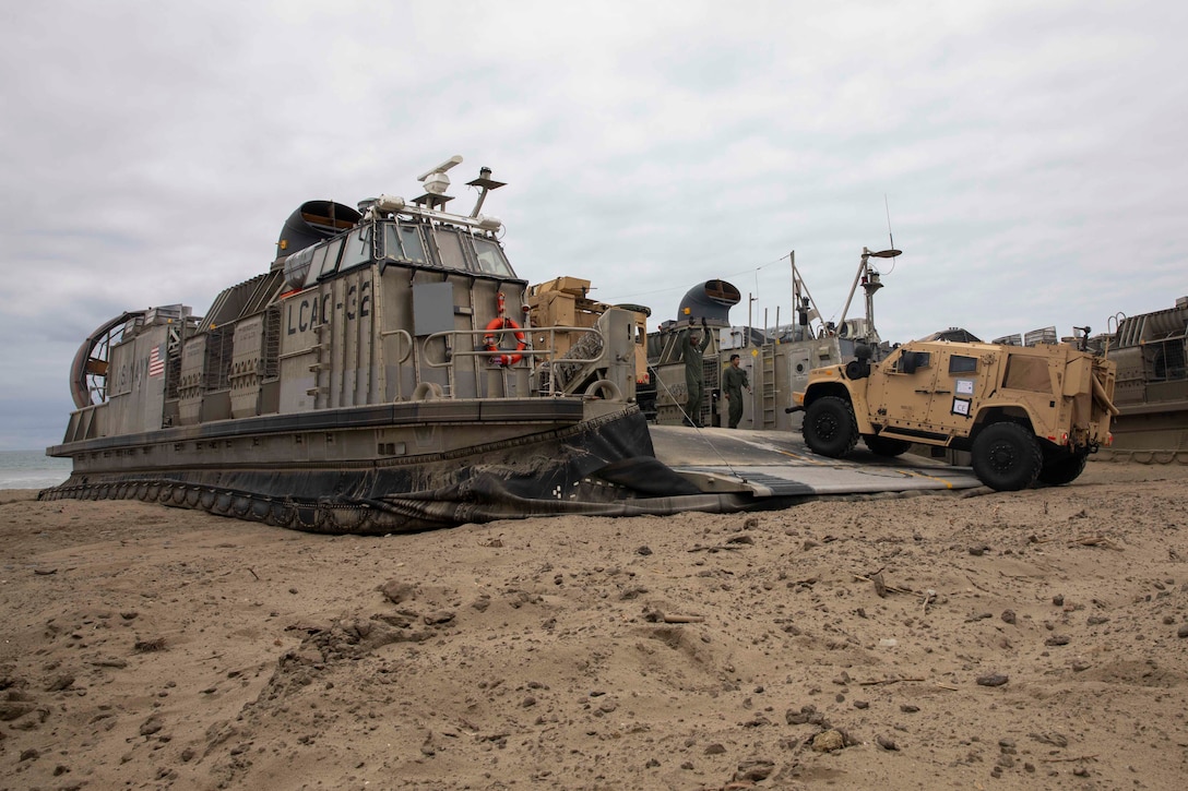 A joint light tactical vehicle (JLTV) with the 3d Assault Amphibian Battalion, 1st Marine Division, 13th Marine Expeditionary Unit (MEU) departs a landing craft, air cushion (LCAC) assigned to Assault Craft Unit (ACU) 5, embarked aboard amphibious assault ship USS Makin Island (LHD 8), at Marine Corps Base Camp Pendleton, California, June 6, 2023. The amphibious capability of the Navy and Marine Corps team has been demonstrated in a broad range of operations including foreign humanitarian assistance operations, noncombatant emergency evacuations, natural disaster response, the recovery of downed aircraft and personnel, counter-piracy and strike operations, and diverse support to our partner nations. The Makin Island Amphibious Ready Group, comprised of Makin Island and amphibious transport docks USS Anchorage (LPD 23) and USS John P. Murtha (LPD 26), is underway conducting routine operations in the U.S. 3rd Fleet with the embarked 13th MEU. (U.S. Navy photo by Mass Communication Specialist 2nd Class Chu)