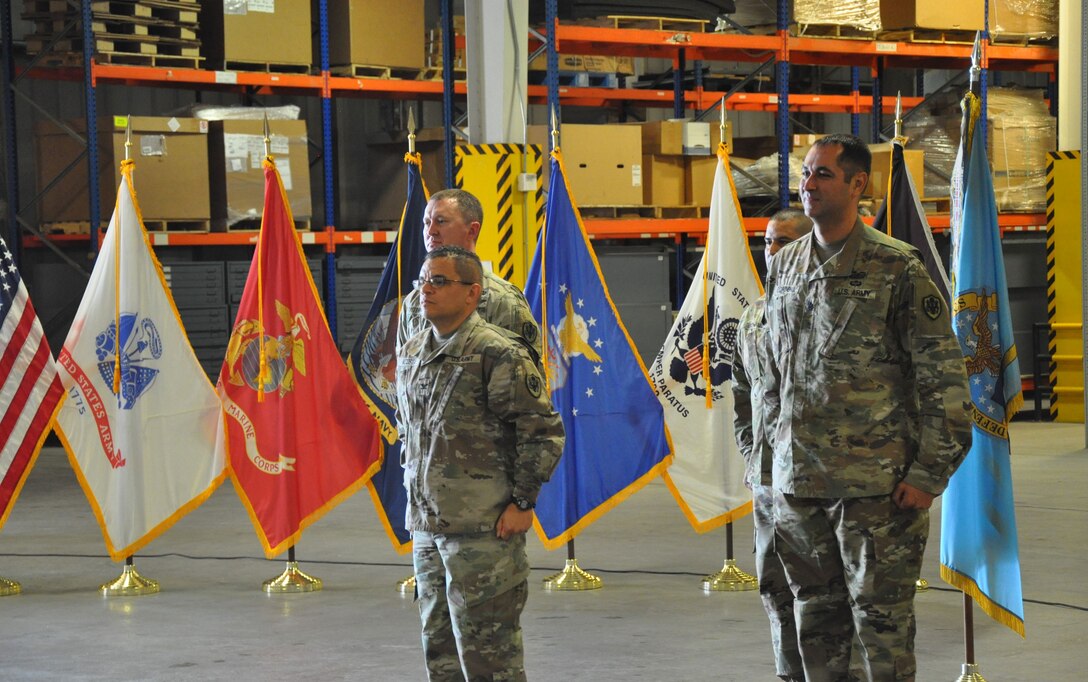 military officers in uniform stand at attention