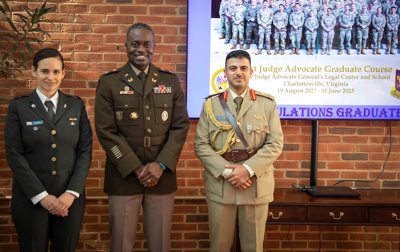 Col. Shawn Smith, U.S. Army Central staff judge advocate, visits Maj. Chen Shmallo-Mantzur, Israel Defense Forces and Lt. Col. Mohammed Hussein Agele, Iraqi Armed Forces, during their graduation from the 71st Judge Advocate Graduate Course at the Judge Advocate General’s Legal Center and School, in Charlottesville, V.A., June 1, 2023. Smith visited the Judge Advocate General’s Legal Center and School to continue engagement initiatives with the international students and build partnerships. (U.S. Army phot by Sgt. Egypt Johnson)