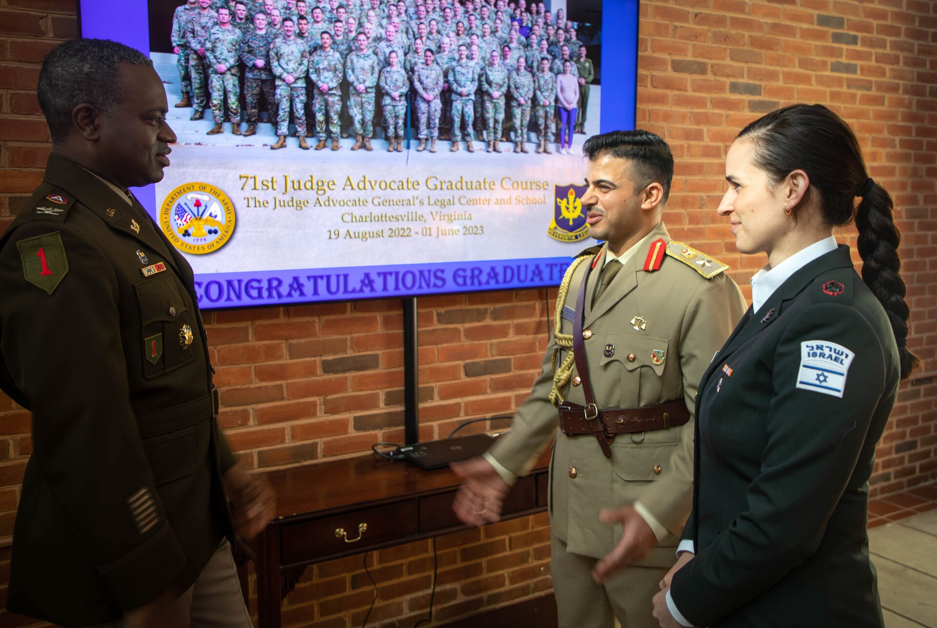 Col. Shawn Smith, U.S. Army Central staff judge advocate, speaks with Maj. Chen Shmallo-Mantzur, Israel Defense Forces and Lt. Col. Mohammed Hussein Agele, Iraqi Armed Forces, before their graduation from the 71st Judge Advocate Graduate Course at the Judge Advocate General’s Legal Center and School, in Charlottesville, V.A., June 1, 2023. Smith congratulated the students for their successful completion of the 71st Judge Advocate Graduate Course. (U.S. Army photo by Sgt. Egypt Johnson)