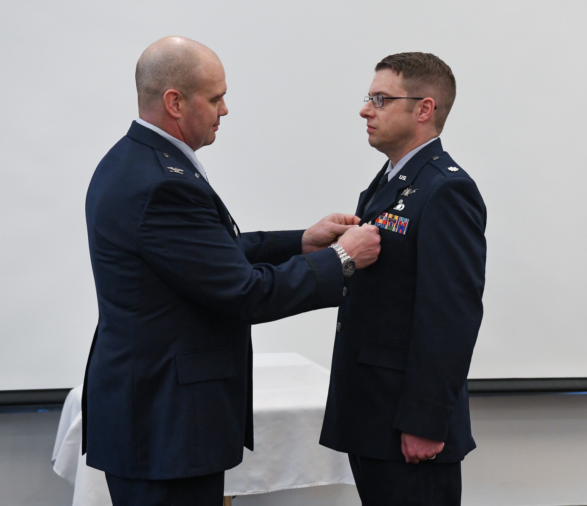 Air Force officer presenting fellow officer with a medal