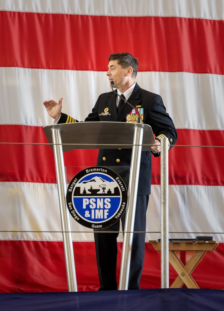 Capt. JD Crinklaw, commander, Puget Sound Naval Shipyard & Intermediate Maintenance Facility, addresses audience members May 25, 2023, during a change-of-command ceremony in Building 460 at the shipyard in Bremerton, Washington. (U.S Navy photo by Wendy Hallmark)
