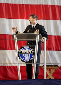 Capt. JD Crinklaw, commander, Puget Sound Naval Shipyard & Intermediate Maintenance Facility, addresses audience members May 25, 2023, during a change-of-command ceremony in Building 460 at the shipyard in Bremerton, Washington. (U.S Navy photo by Wendy Hallmark)