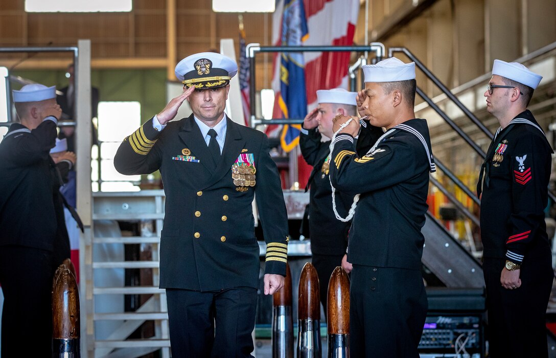 Capt. JD Crinklaw, commander, Puget Sound Naval Shipyard & Intermediate Maintenance Facility, salutes as he departs May 25, 2023, following a change-of -command ceremony at the shipyard in Bremerton, Washington. (U.S. Navy photo by Scott Hansen)