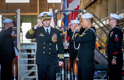 Capt. JD Crinklaw, commander, Puget Sound Naval Shipyard & Intermediate Maintenance Facility, salutes as he departs May 25, 2023, following a change-of -command ceremony at the shipyard in Bremerton, Washington. (U.S. Navy photo by Scott Hansen)