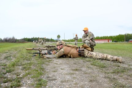 Alaska Army National Guard Staff Sgt. Travis Hall, 49th Missile Defense Battalion (GMD), fires a M110 A1 Marksman Rifle as AKARNG Maj. James Goddard, officer in charge of the TAG Match, acts as a range safety at the Fort Wainwright Range Complex June 4, 2023. The TAG Match is an annual marksmanship competition designed to challenge and test basic shooting fundamentals.