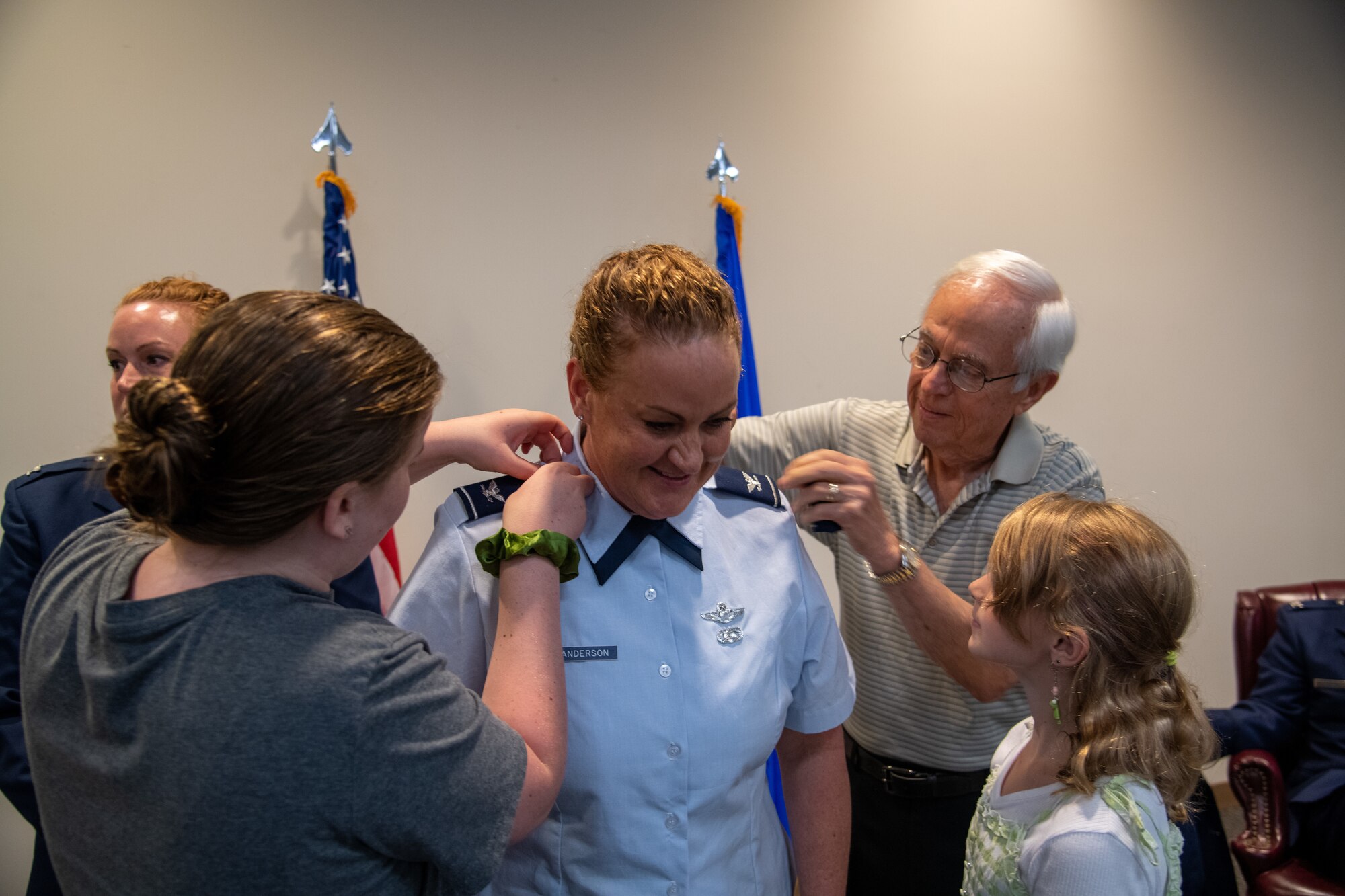 Female military member is pinned with colonel rank by her family