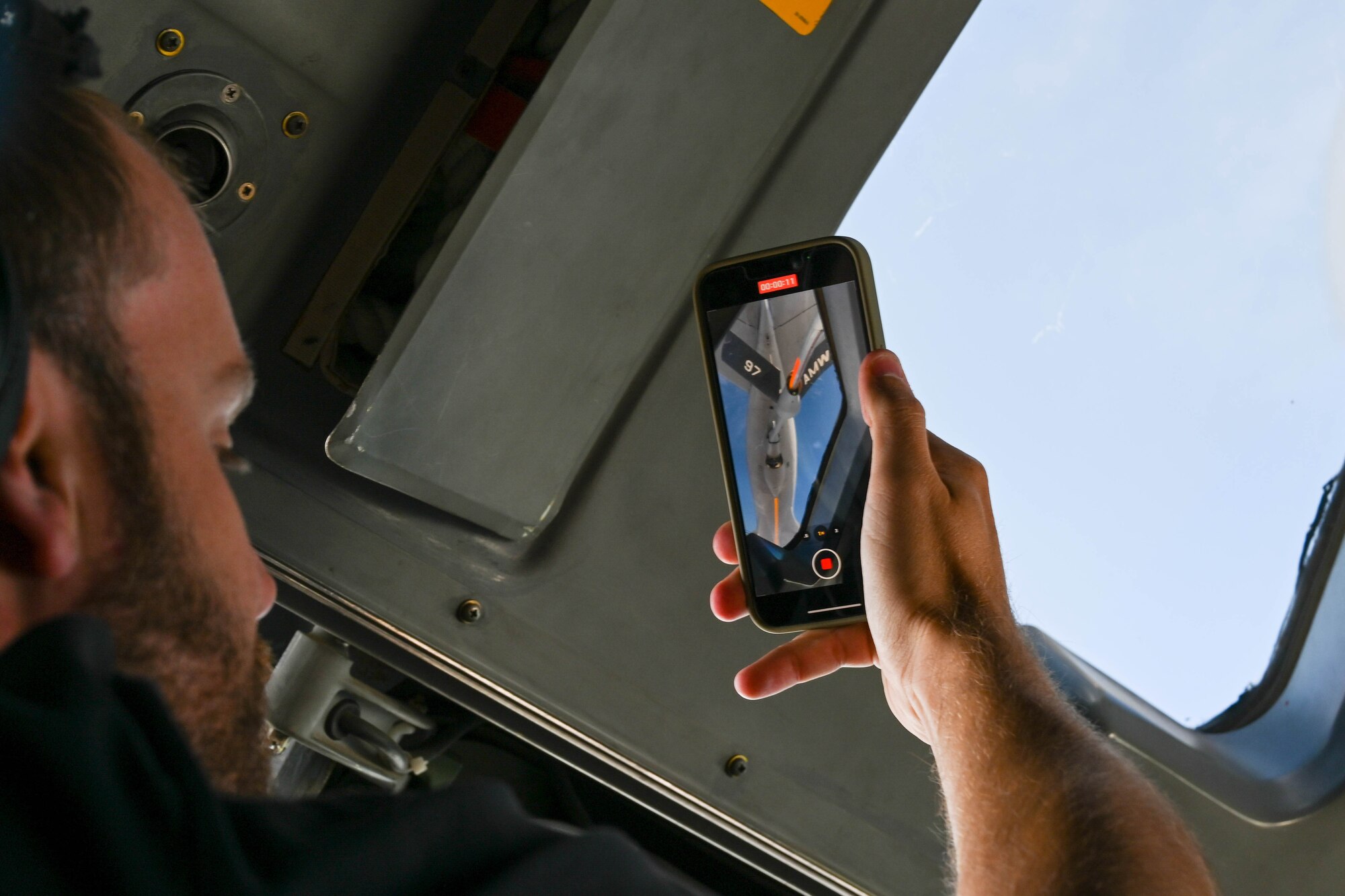 Cody Nelson, Altus Military Affairs Committee member, takes a video of a KC-135 Stratotanker, June 6, 2023. The 97th Air Mobility Wing is home to the Air Force’s only KC-135, KC-46 Pegasus, and C-17 Globemaster III formal training units. (U.S. Air Force photo by Senior Airman Trenton Jancze)