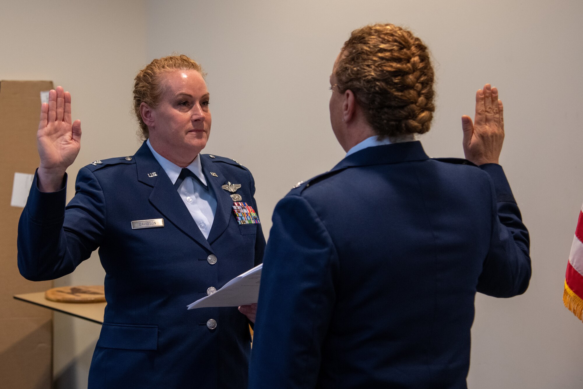 One military female issues the oath to her twin sister.