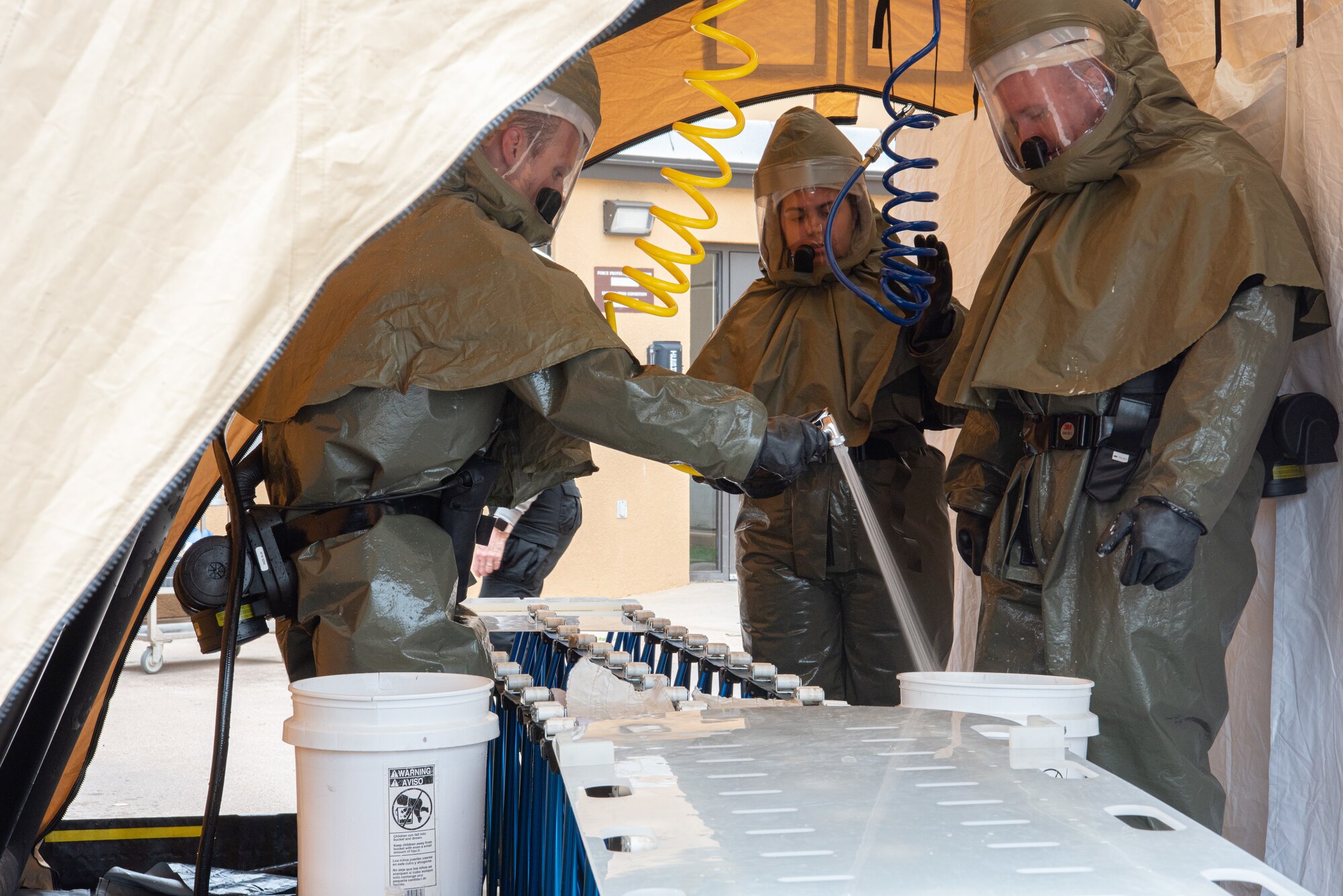 Airmen from the 7th Medical Group sanitize the simulated casualty area during a decontamination exercise at Dyess Air Force Base, Texas, June 1, 2023.The exercise required the completion of a three-day training course that tested Airmen’s medical disaster response. (U.S. Air Force photo by Airman 1st Class Alondra Cristobal Hernandez)