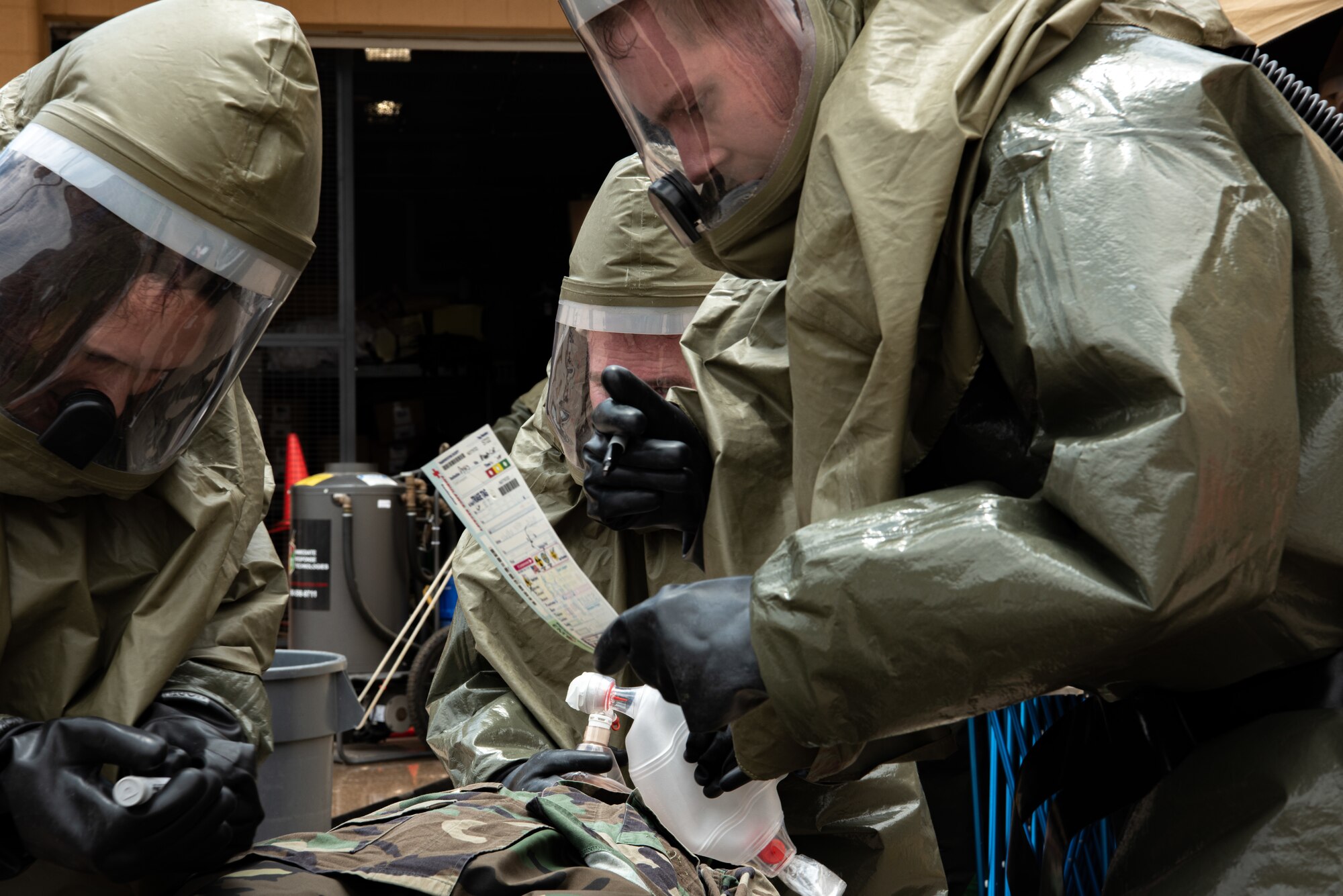 Airmen from the 7th Medical Group perform triage care in protective suits during a decontamination exercise at Dyess Air Force Base, Texas, June 1, 2023.The exercise required the completion of a three-day training course that tested Airmen’s medical disaster response. (U.S. Air Force photo by Airman 1st Class Alondra Cristobal Hernandez)