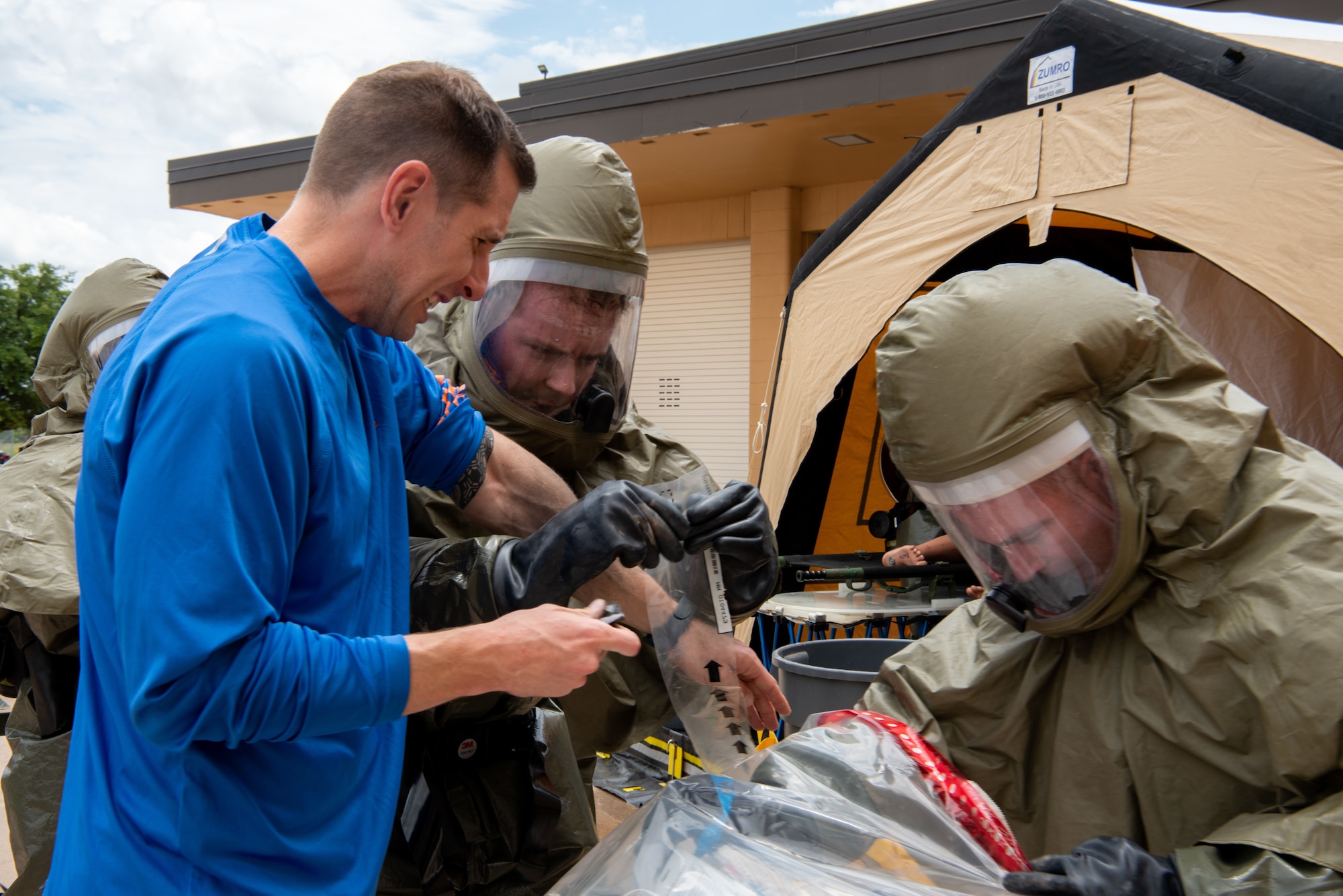 Airmen from the 7th Medical Group direct a simulated contaminated Airman through the rinse station during a decontamination exercise at Dyess Air Force Base, Texas, June 1, 2023. The exercise required the completion of a three-day training course that tested Airmen’s medical disaster response. (U.S. Air Force photo by Airman 1st Class Alondra Cristobal Hernandez)