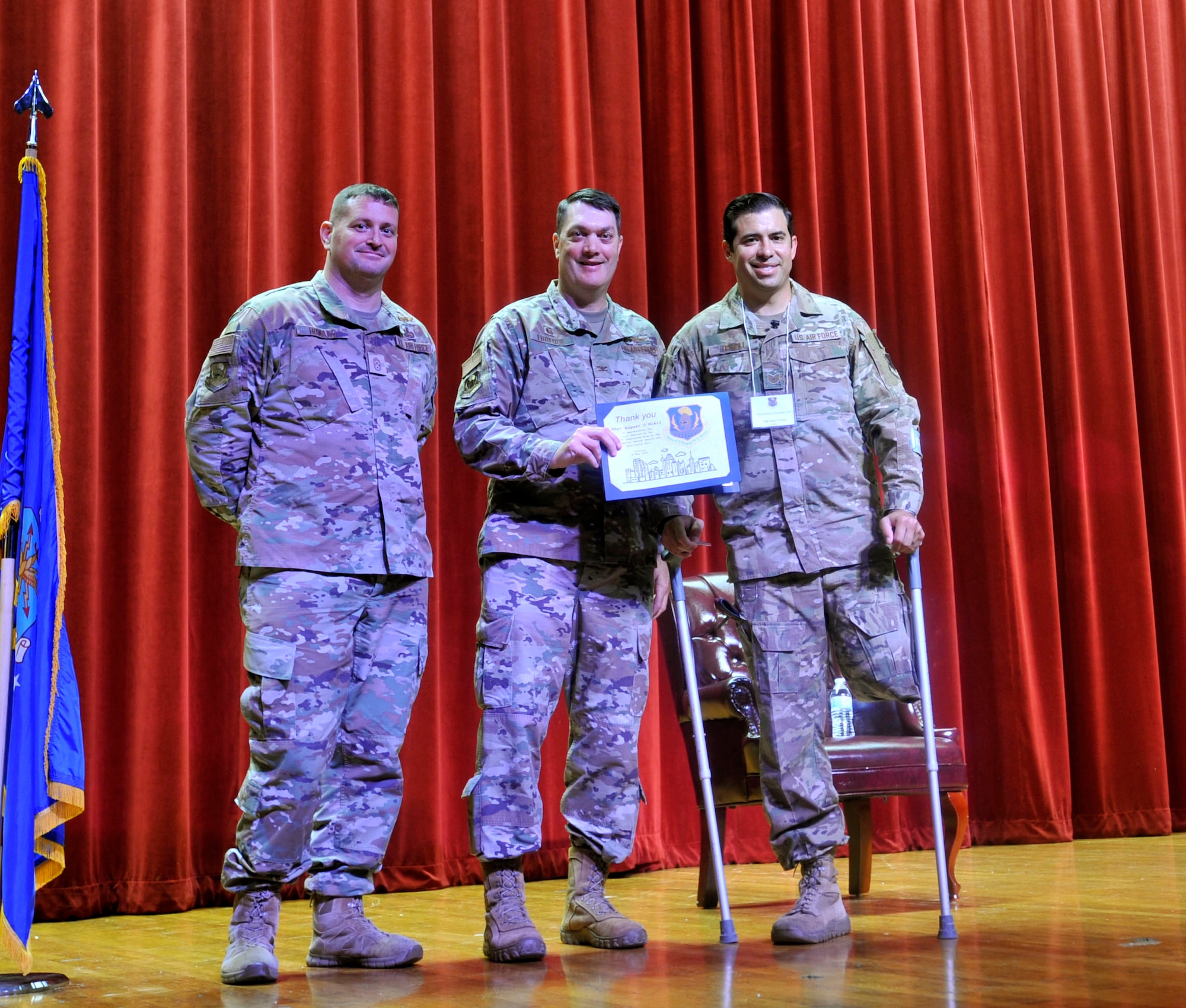 Col. Richard Erredge, Chief Master Sgt. Christopher Howard, and Tech. Sgt. August O’Niell pose for a photo at Joint Base San Antonio-Lackland, Texas on May 6, 2023. O’Niell is a 5-time gold medalist for the Invictus Games, an international multi-sport event for wounded, injured, or afflicted servicemembers intended to inspire recovery, support, and awareness. (U.S. Air Force photo by Alex Dieguez)