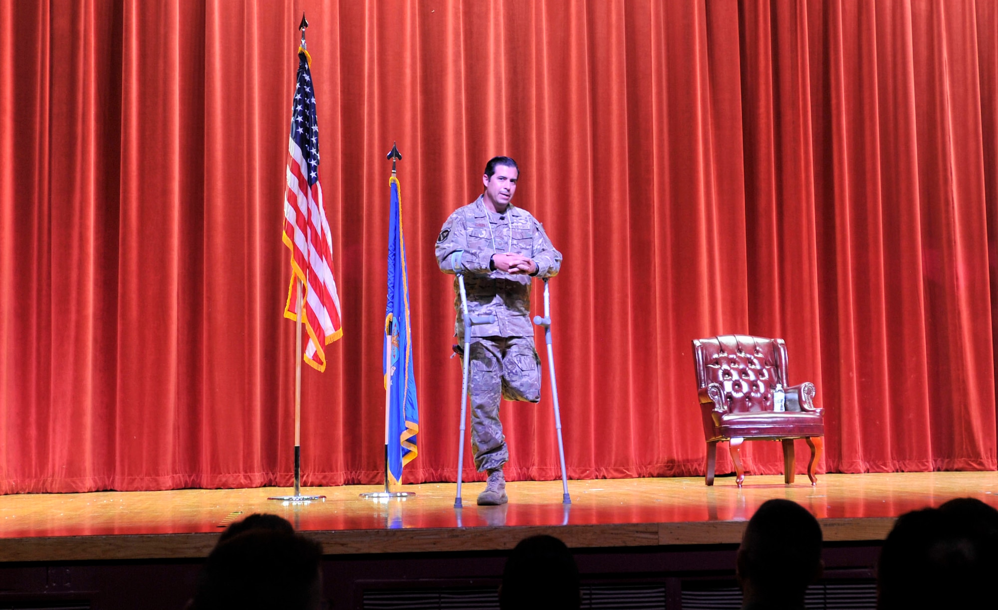 Tech. Sgt. August O’Niell shares his story of physical and mental resiliency with attendees at Joint Base San Antonio-Lackland, Texas on May 6, 2023. Ordinarily with a prosthetic, O’Niell explains a recent surgery requires him to forego the mobility aid for conventional crutches and that his limitations are minimal with respect to his motivations. (U.S. Air Force photo by Alex Dieguez)