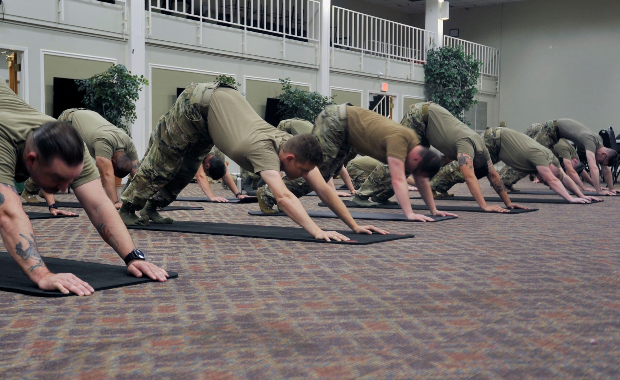 Airmen participate in a yoga session hosted by the Pink Berets at Joint Base San Antonio-Lackland, Texas on May 6, 2023. As a low-intensity exercise, yoga supports stress management, physical mobility, and mindfulness, and mental health. (U.S. Air Force photo by Alex Dieguez)