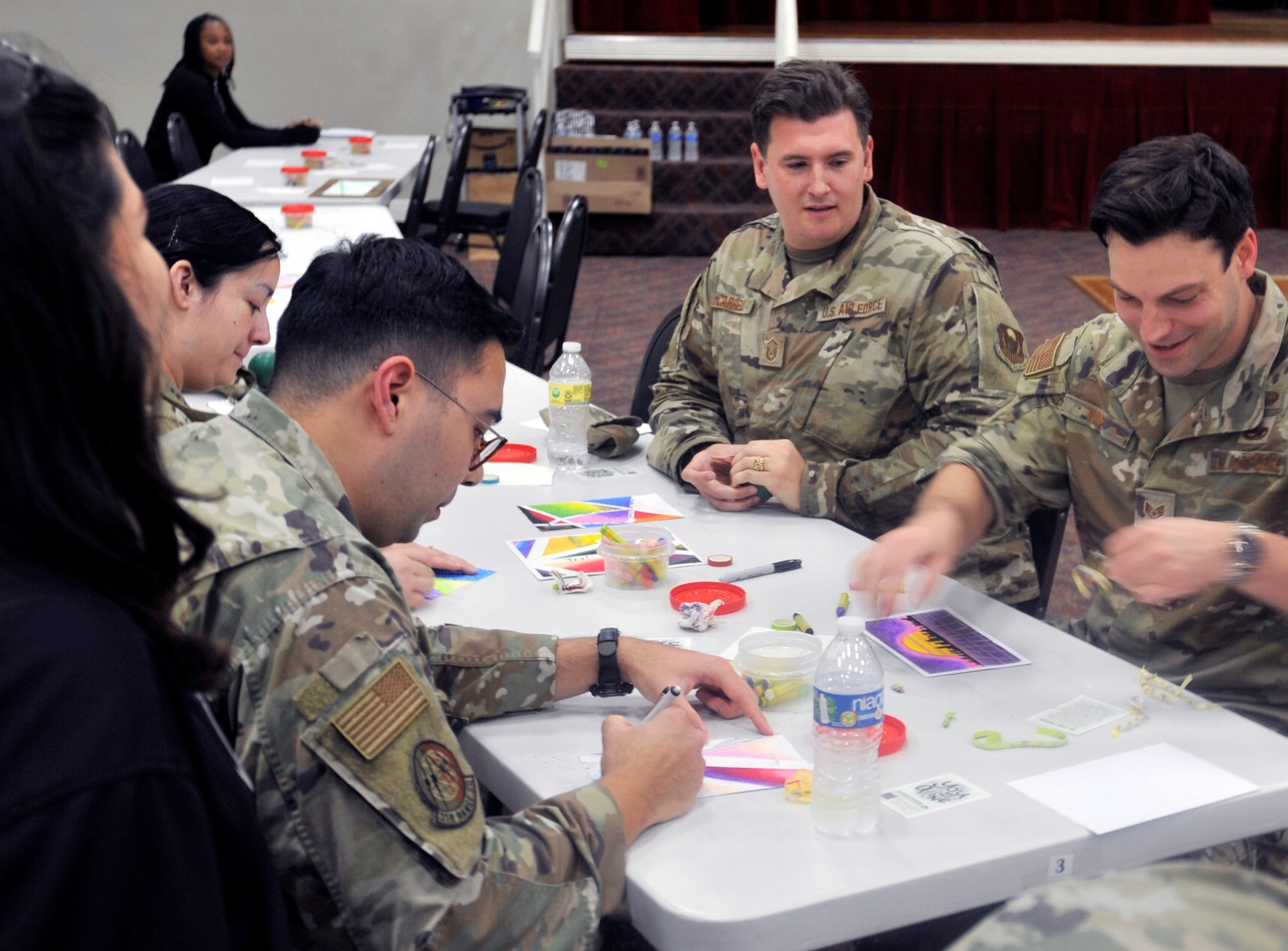 Airmen from different units participate in an Expressive Arts Therapy activity at Joint Base San Antonio-Lackland, Texas on May 6, 2023. The session, hosted by the Recreation Therapy Team from the San Antonio Behavioral Healthcare Hospital, focuses on using a creative outlet to process mental expression, facilitate memory functions, and relieve anxieties or stress. (U.S. Air Force photo by Alex Dieguez)