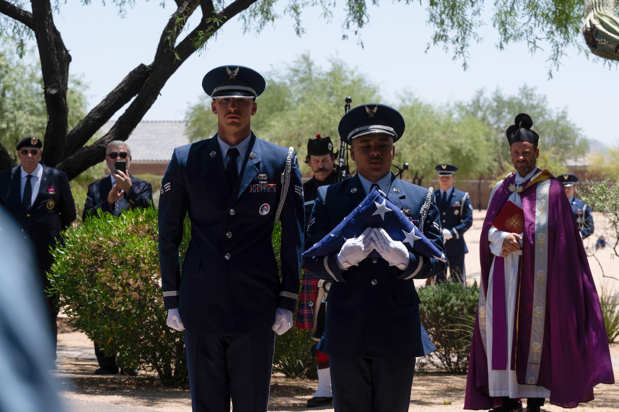 U.S. Air Force Senior Airman Tyler Smith and Airman 1st Class Andrew Liang, Luke Honor Guardsmen, conduct a flag folding ceremony at retired U.S. Air Force Lt. Col. Edwin “Skip” Hopler’s funeral and internment, at the National Memorial Cemetery, June 6, 2023, in Phoenix, Arizona.