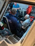 Men sit in the cabin of an MLB