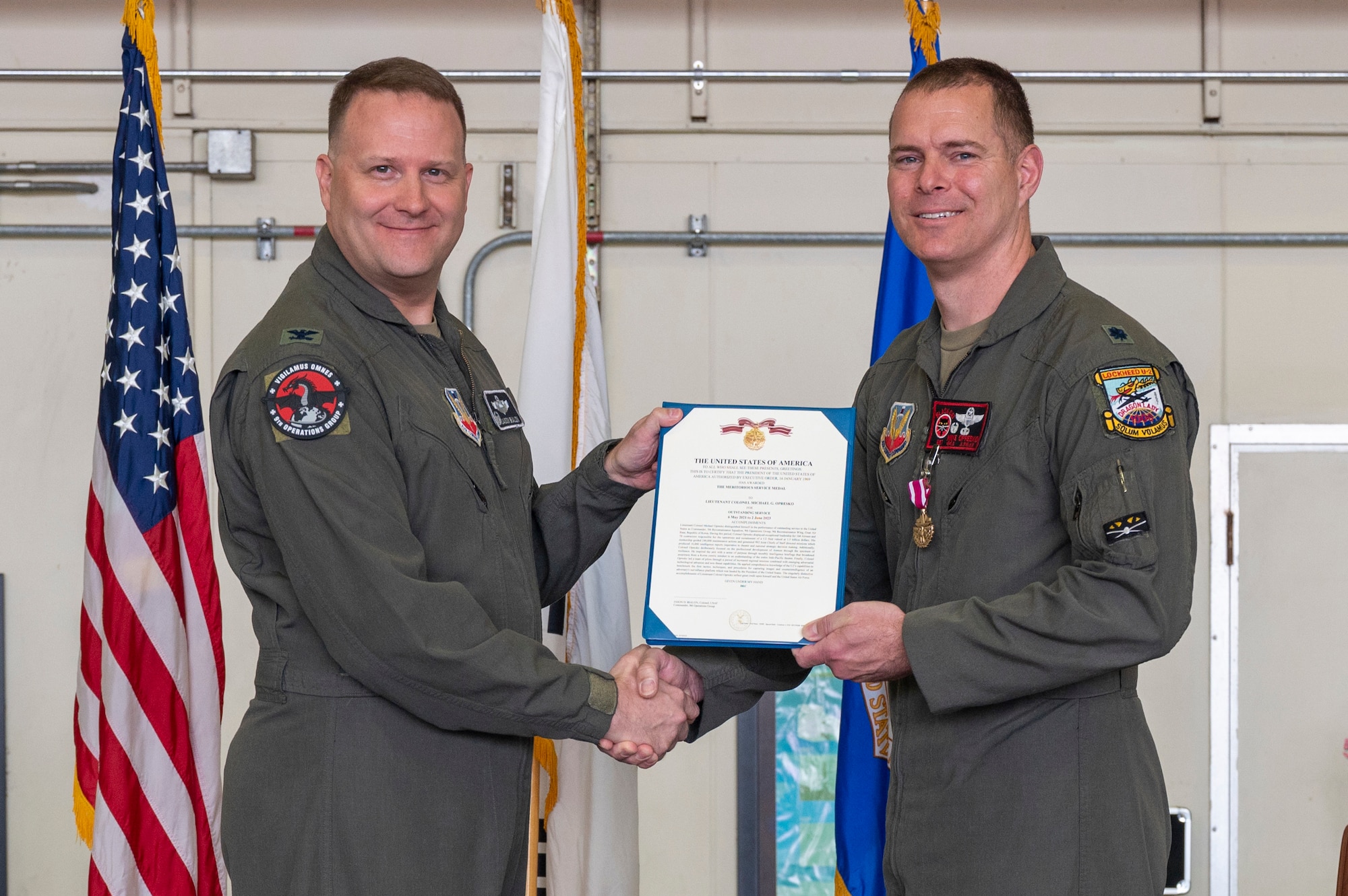 U.S. Air Force Col. Jason Bialon, left, 9th Operations Group commander, presents a Meritorious Service Medal to Lt. Col. Michael Opresko, 5th Reconnaissance Squadron commander, at Osan Air Base, Republic of Korea, June 2, 2023. The MSM is a military decoration awarded by various branches of the Armed Forces to recognize distinguished or outstanding meritorious service.  (U.S. Air Force photo by Airman 1st Class Aaron Edwards)