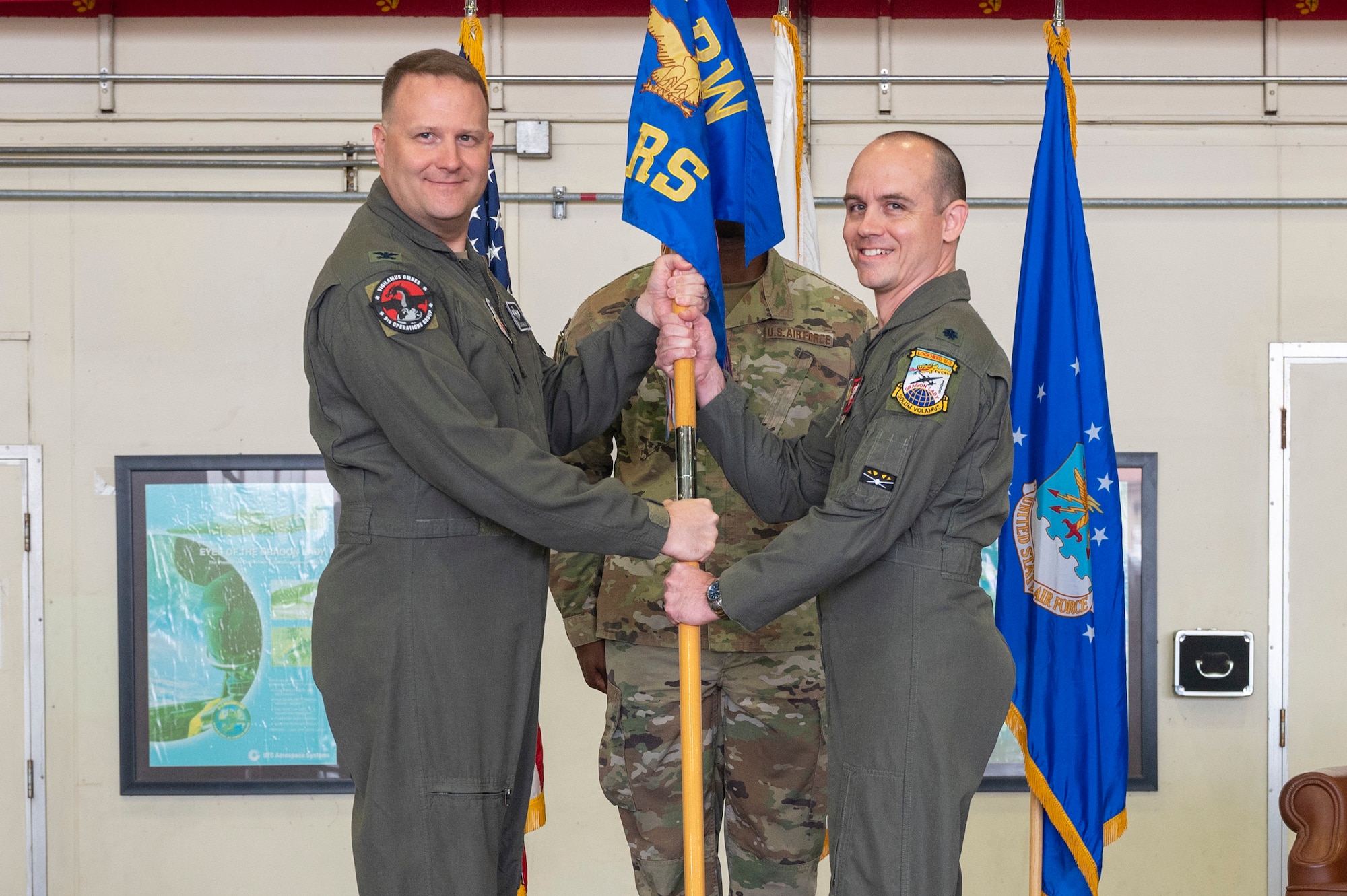 U.S. Air Force Col. Jason Bialon, left, 9th Operations Group commander, presents the guidon to Lt. Col. Brandon Olson, 5th Reconnaissance Squadron incoming commander, as a symbol of his taking command of the 5th RS at Osan Air Base, Republic of Korea, June 2, 2023. Prior to taking command, Olson served as the 5th RS director of operations. (U.S. Air Force photo by Airman 1st Class Aaron Edwards)