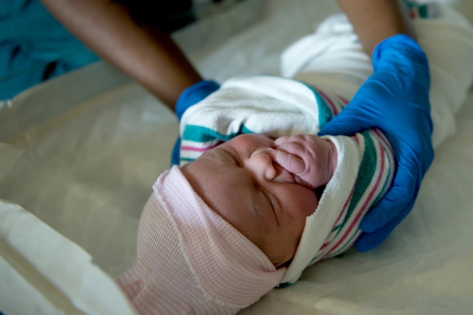 U.S. Air Force Staff Sgt. Tanshanika Thompson, 633rd Inpatient Squadron medical technician, performs a routine check-up on Addalyn Grace Hendrick, daughter of Master Sgt. Scott Hendrick, Air Combat Command Headquarters functional manager, at Langley Air Force Base, Va., June 27, 2016. After delivery, to ensure proper recovery time, first-time mothers must spend at least 48 hours in the labor and delivery unit. (U.S. Air Force photo by Airman 1st Class Kaylee Dubois)