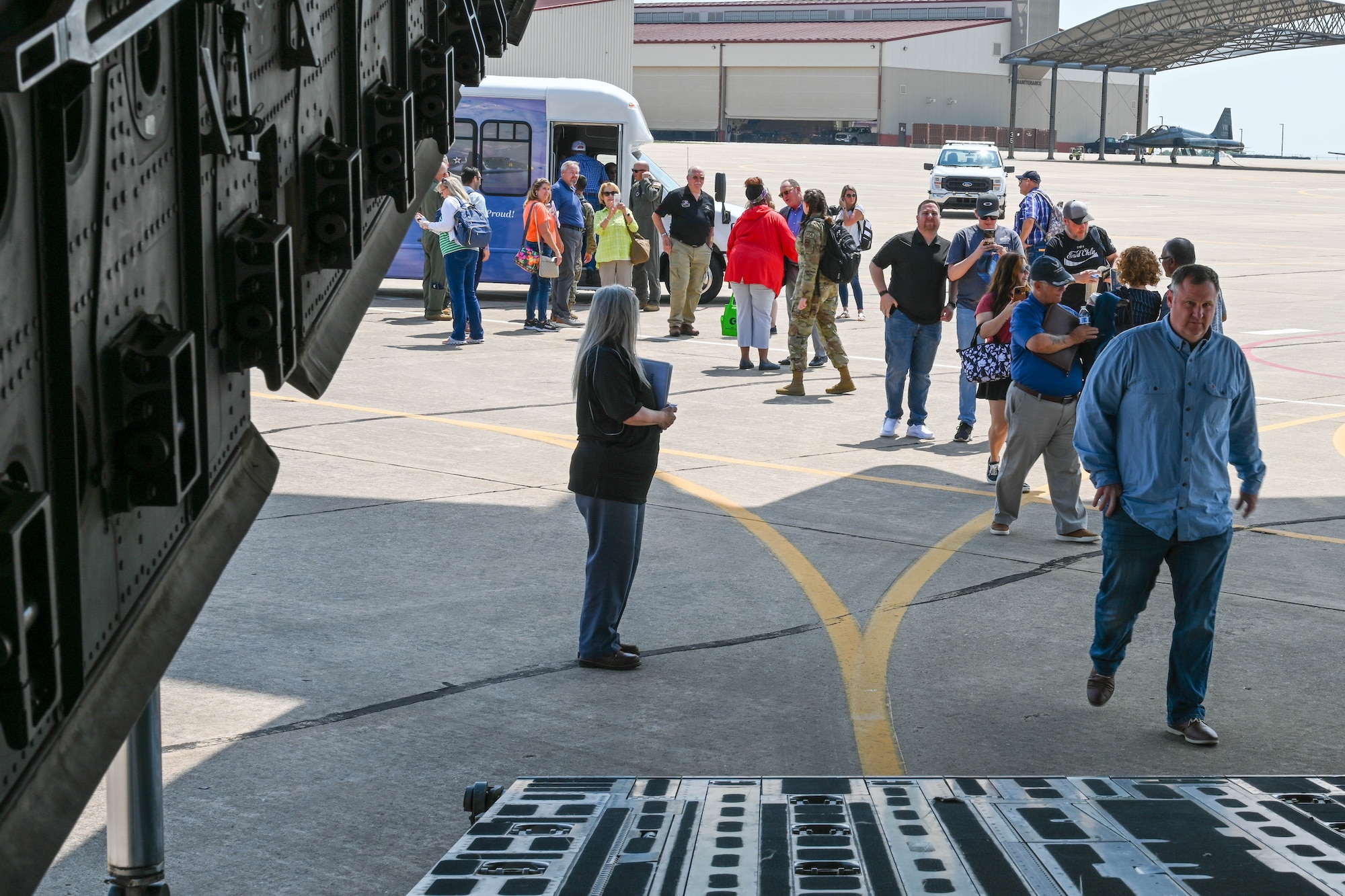 Vance Air Force Base (AFB) civic leaders walk onto a C-17 Globemaster III on the flight line at Vance AFB, Oklahoma June 6, 2023. The civic leaders were able to ask the aircrew questions about the aircraft, as well as explore the thunder dome area and cockpit during their flight. (U.S. Air Force photo by Senior Airman Trenton Jancze)