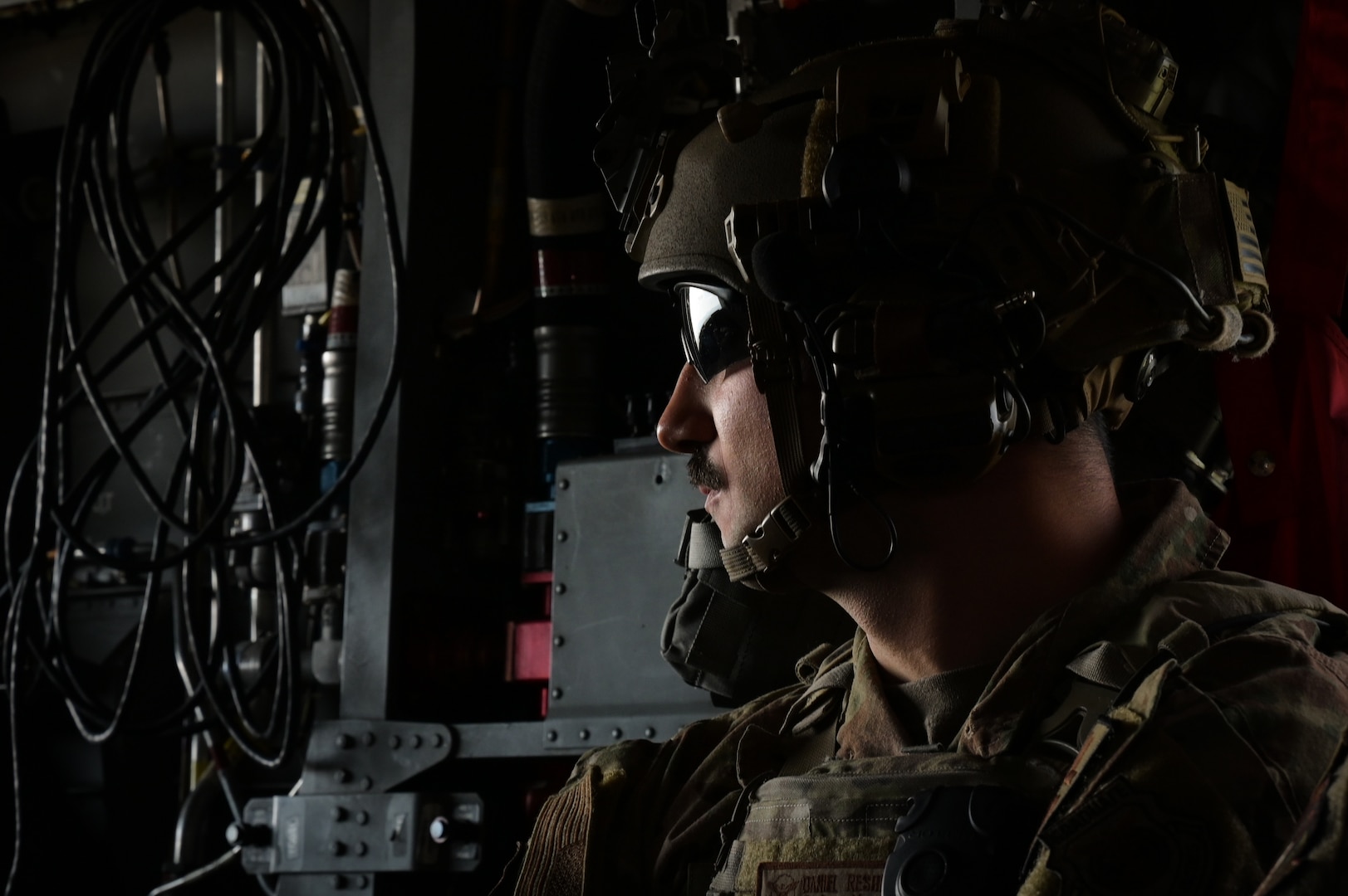 Tech. Sgt. Daniel Reshef, 841st Missile Security Forces flight chief, looks out the back of a U.S. Army CH-47 Chinook as it flies to Fort William Henry Harrison, Mont., May 30, 2023. Fort Harrison was the designated location of Operation Avalanche Defender, a four-day exercise that was created based on the Air Force Future Operating Concept.