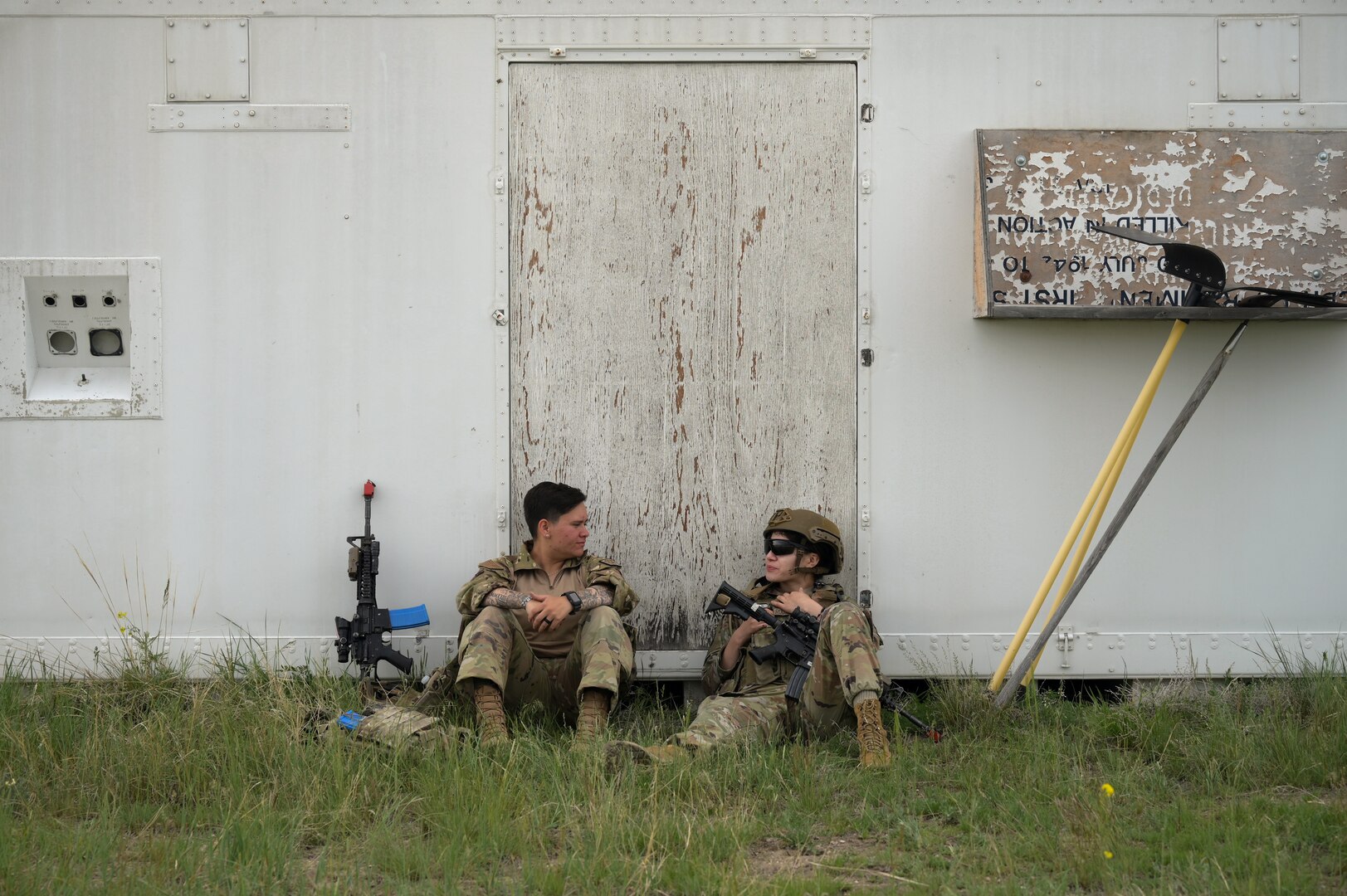 Airman 1st Class Izabel Meyer, left, and Airman 1st Class Samantha Rodarte Leon, 841st Missile Security Forces Squadron missile security operators, take a break between team movement drills at Fort William Henry Harrison, Mont., May 31, 2023. Airmen with the 841st MSFS trained for four days during Operation Avalanche Defender in a simulated deployment environment.