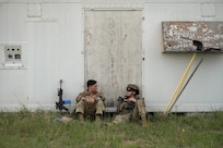 Airman 1st Class Izabel Meyer, left, and Airman 1st Class Samantha Rodarte Leon, 841st Missile Security Forces Squadron missile security operators, take a break between team movement drills at Fort William Henry Harrison, Mont., May 31, 2023. Airmen with the 841st MSFS trained for four days during Operation Avalanche Defender in a simulated deployment environment.