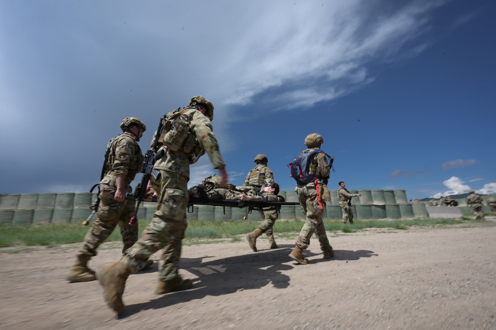 Airmen with the 841st Missile Security Forces Squadron
transport a simulated injured teammate via stretcher to an
awaiting U.S. Army UH-60 Black Hawk at Fort William
Henry Harrison, Mont., May 30, 2023. The Airmen
participated in the four-day Operation Avalanche Defender,
which was designed to exercise close-quarters combat,
weapon employments. Team movements and medical
training.