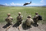 Tech. Sgt. Cameron Gumm, 841st Missile Security Forces Squadron squad leader, left, folds a visibility marker as Tech. Sgt. Daniel Reshef, 841st MSFS flight chief, stands by for the arrival of a U.S. Army UH-60 Black Hawk at Fort William Henry Harrison, Mont., May 31, 2023. The Montana National Guard joined the 841st MSFS for Operation Avalanche Defender, a four-day simulated deployment exercise.