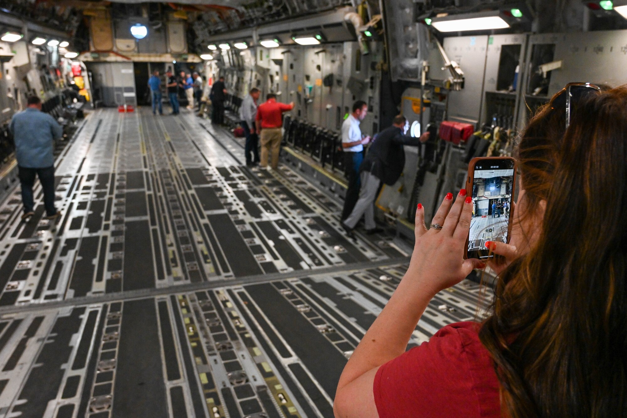Taylor Blasier, Vance Air Force Base civic leader, takes a video of the cargo loading area on a C-17 Globemaster III, June 6, 2023. The C-17 is 174 feet long and has a maximum payload of 170,900 pounds. (U.S. Air Force photo by Senior Airman Trenton Jancze)