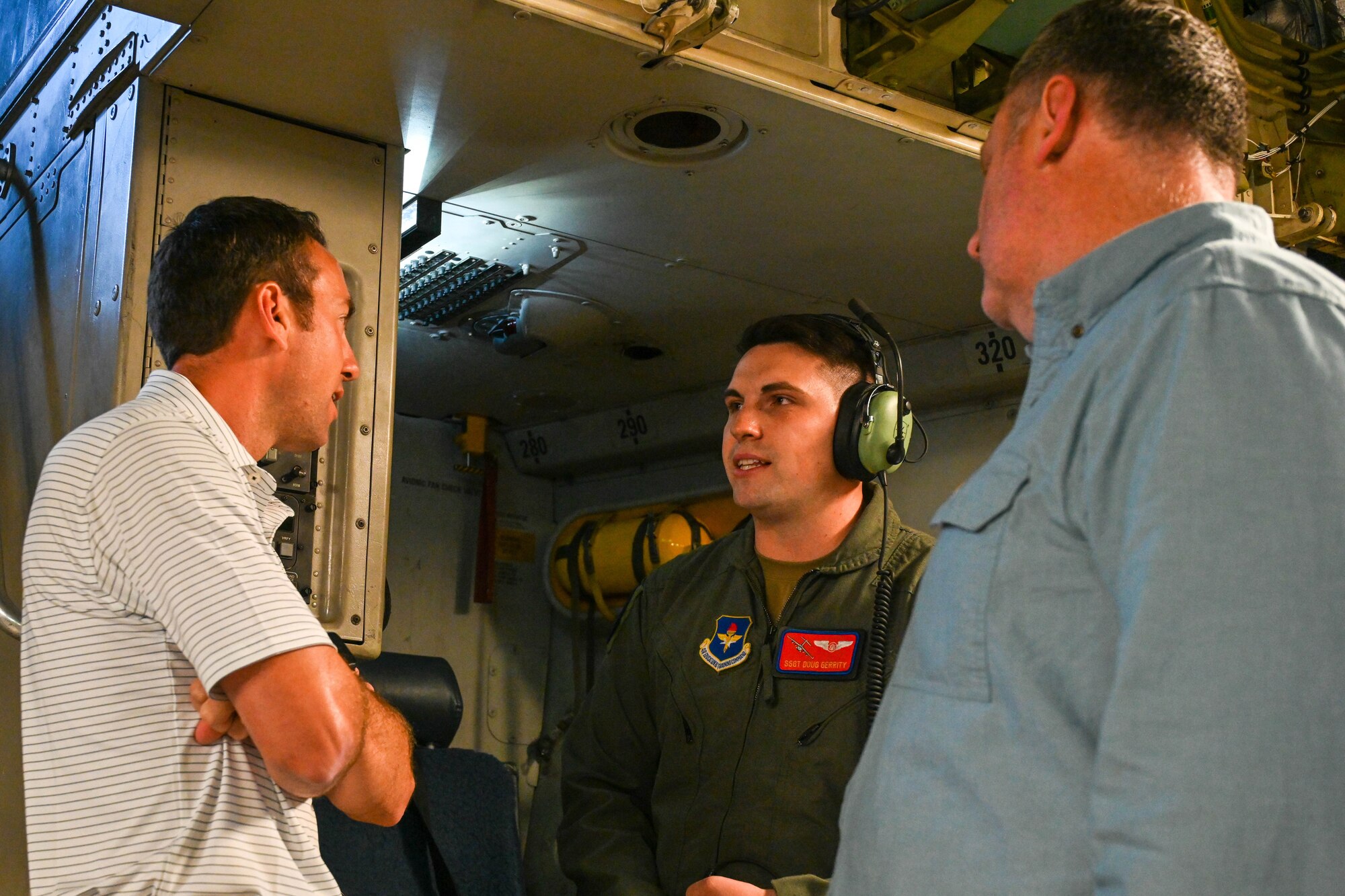 U.S. Air Force Staff Sgt. Doug Gerrity, 58th Airlift Squadron loadmaster instructor, answers questions from Keaton Francis (left) and Brian Lamoreaux (right), Vance Air Force Base (AFB), Oklahoma, civic leaders, while on a C-17 Globemaster III, June 6, 2023. Altus AFB trains 70% of all mobility aircrew members in the Air Force, while Vance AFB trains more than 300 pilots a year, 60 percent of whom move onto Altus for their formal training on the KC-135 Stratotanker, KC- 46 Pegasus, or C-17. (U.S. Air Force photo by Senior Airman Trenton Jancze)