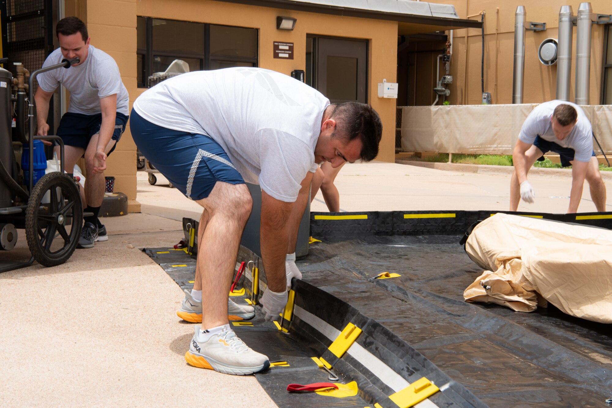 Airmen from the 7th Medical Group build a wash tent during a decontamination exercise at Dyess Air Force Base, Texas, June 1, 2023. The exercise required the completion of a three-day training course that tested Airmen’s medical disaster response. (U.S. Air Force photo by Airman 1st Class Alondra Cristobal Hernandez)