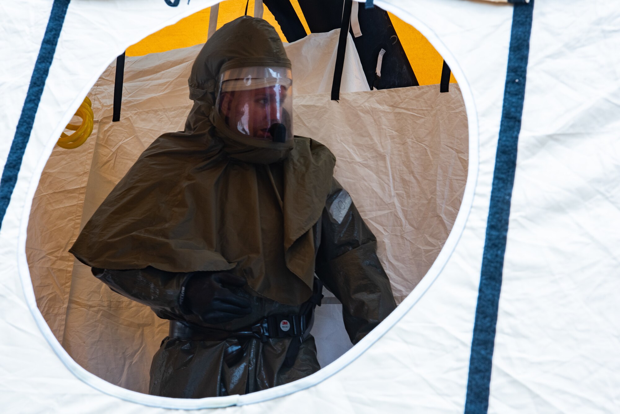 An Airman from the 7th Medical Group goes through the rinse station during a decontamination exercise at Dyess Air Force Base, Texas, June 1, 2023. The exercise required the completion of a three-day training course that tested Airmen’s medical disaster response. (U.S. Air Force photo by Airman 1st Class Alondra Cristobal Hernandez)