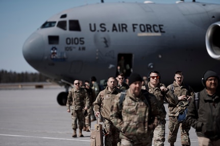 Photo of Airmen assigned to the Vermont Air National Guard's 158th Fighter Wing, from South Burlington, Vermont, sitting onboard a C-17A Globemaster III flown by the New York Air National Guard's 105th Airlift Wing from Newburg, New York, land at Wheeler-Sack Army Airfield , Fort Drum, New York, April 2, 2023.