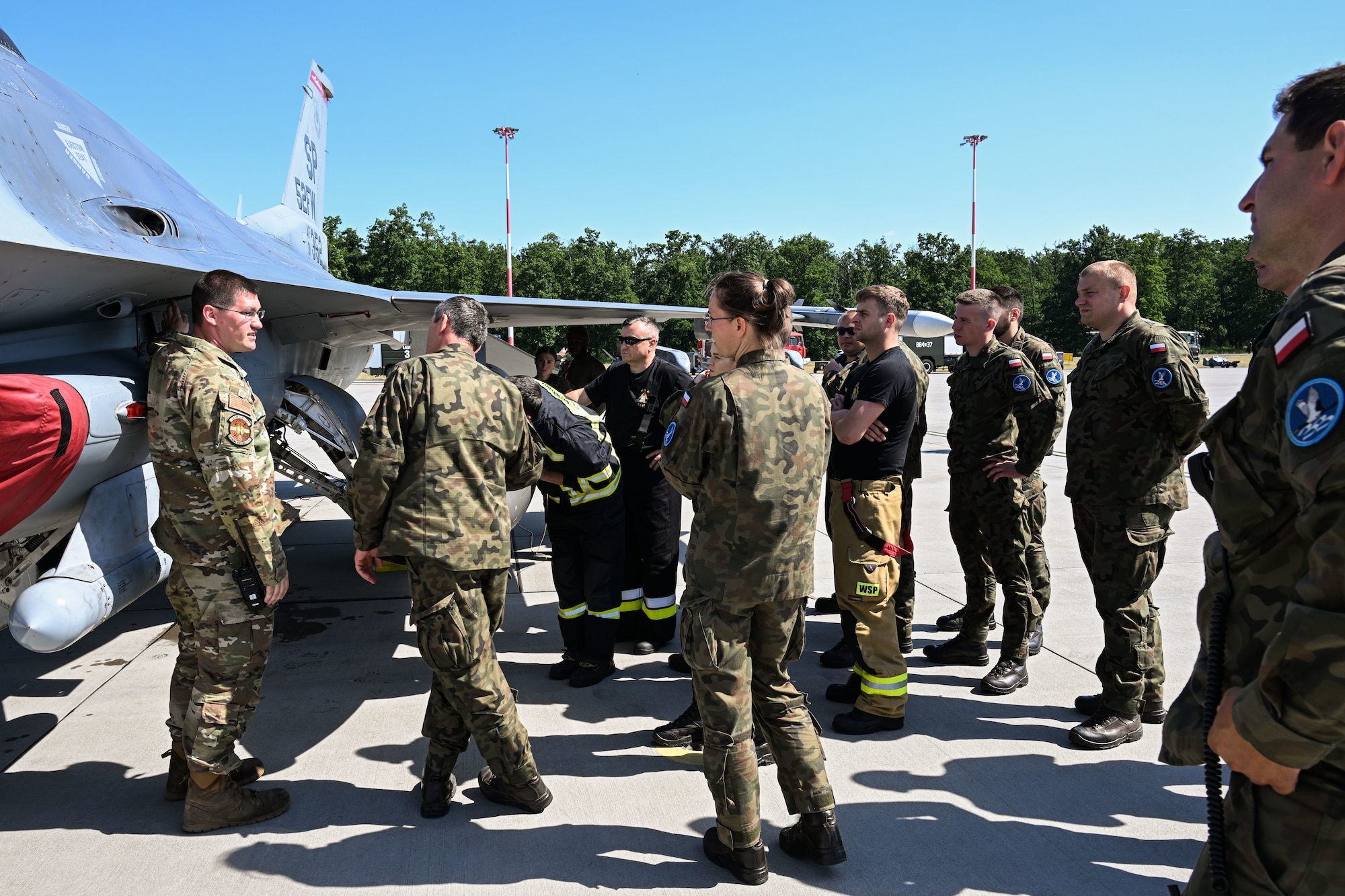 U.S. Air Force Tech. Sgt. Joshua Gorman, 480th Fighter Generation Squadron Crash, Damaged Disabled Aircraft Recovery (CDDAR) team chief, far left, trains Polish fire department members with the 33rd Airlift Base on emergency aircraft procedures at Powidz Air Base, Poland