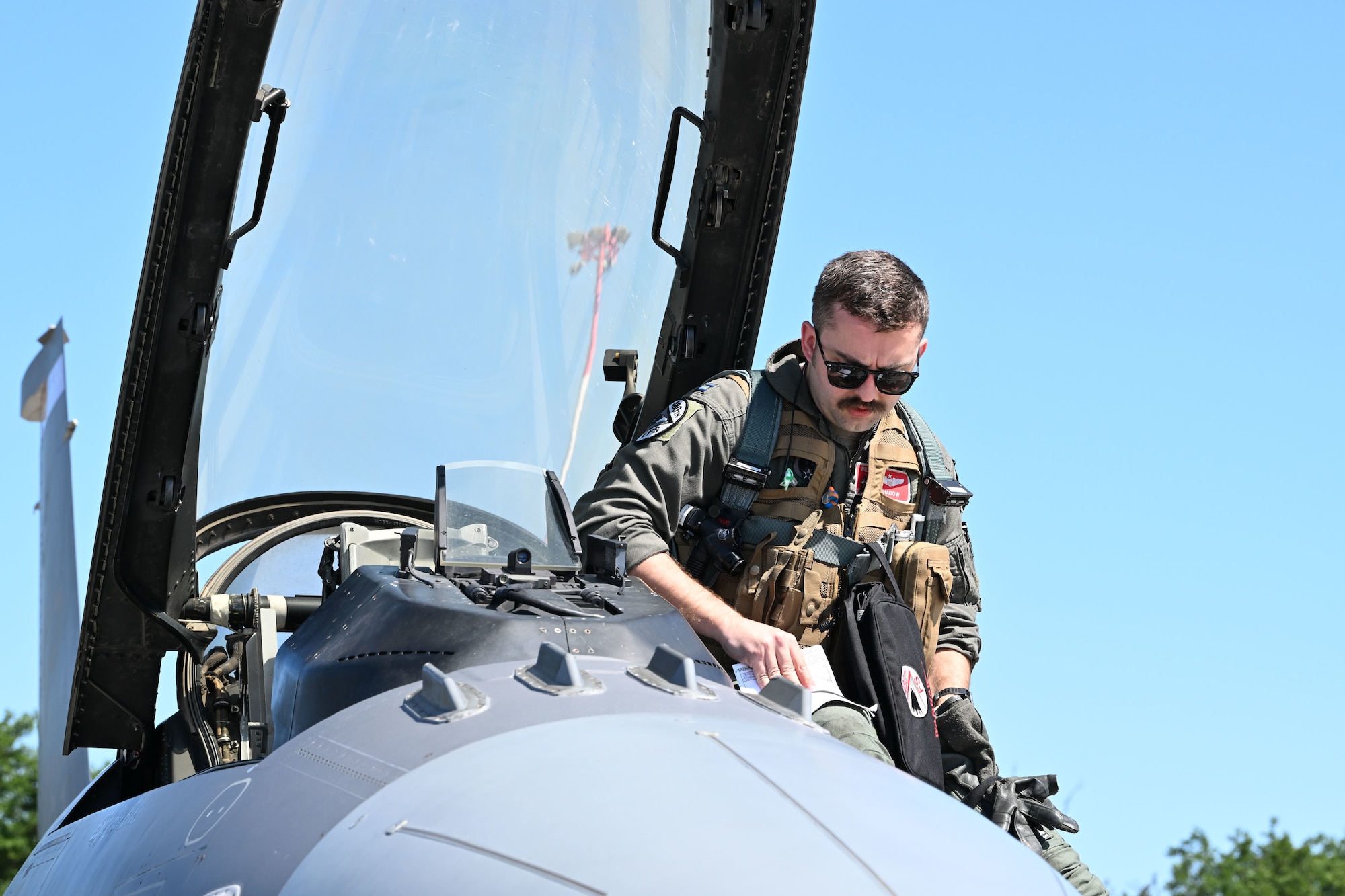U.S. Air Force Capt. Garret Wilson, 480th Fighter Squadron F-16 Fighting Falcon pilot, departs an aircraft upon arrival at Powidz Air Base, Poland