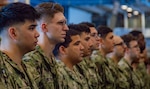 230607-N-JO823-1015 PHILIPPINE SEA (June 7, 2023) Sailors stand in formation during a frocking ceremony in the hangar bay of the U.S. Navy’s only forward-deployed aircraft carrier, USS Ronald Reagan (CVN 76), in the Philippine Sea, June 7, 2023. Ronald Reagan promoted 329 petty officers off the March 2023 Navy-wide Advancement Exam. Ronald Reagan, the flagship of Carrier Strike Group 5, provides a combat-ready force that protects and defends the United States, and supports alliances, partnerships and collective maritime interests in the Indo-Pacific region. (U.S. Navy photo by Mass Communication Specialist 3rd Class Natasha ChevalierLosada)