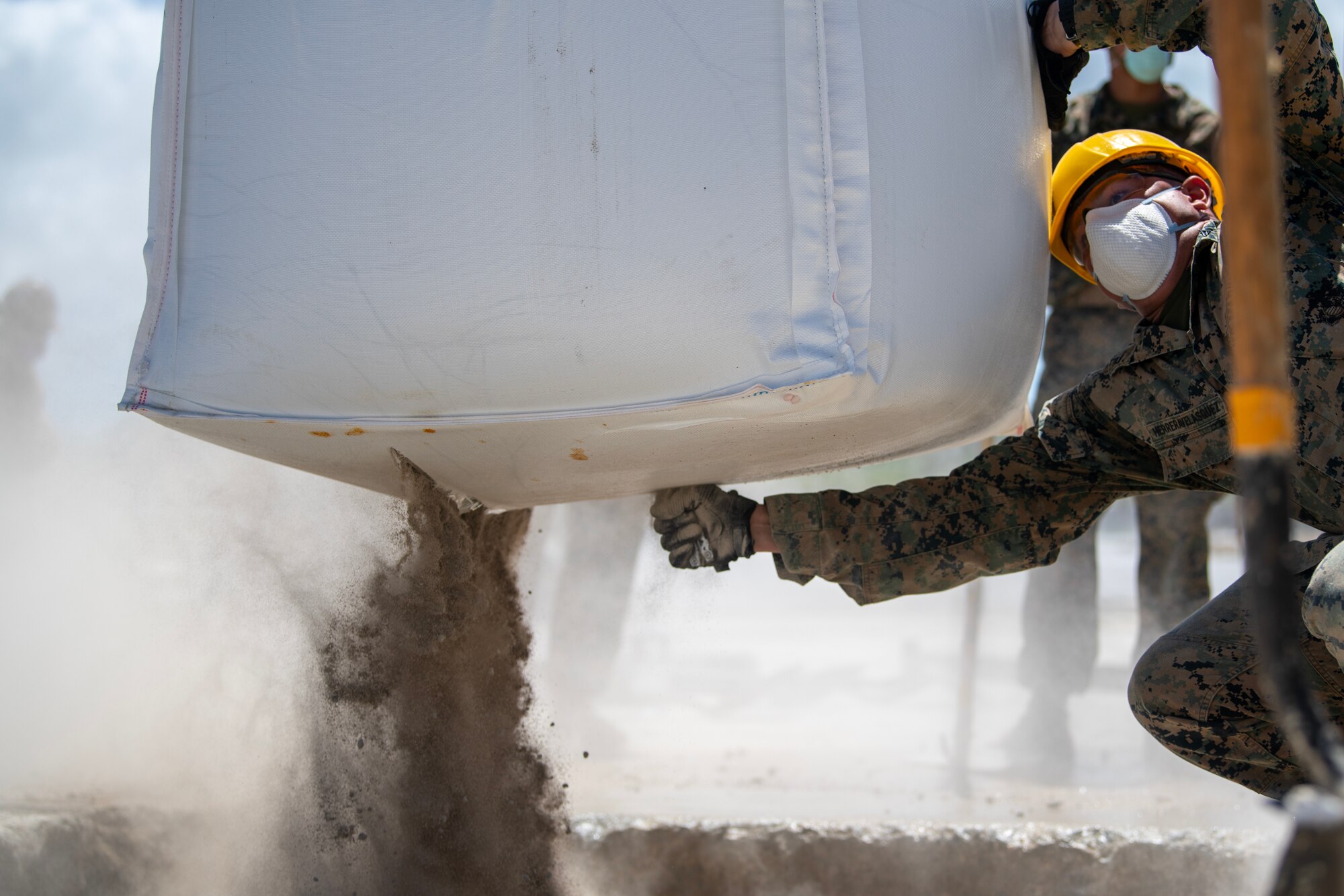 U.S. Marine cutting open concrete sack during RADR exercise