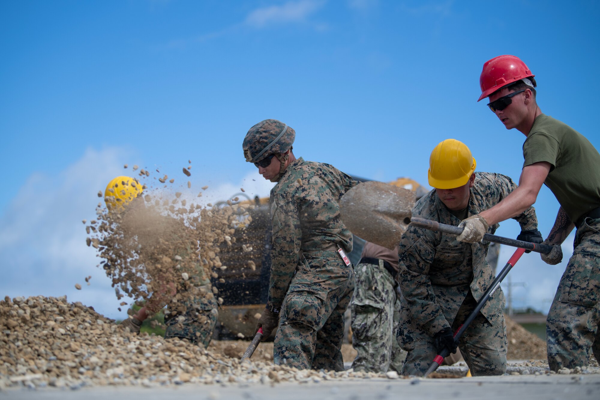 Marines shoveling dirt out of man-made hole during RADR exercise