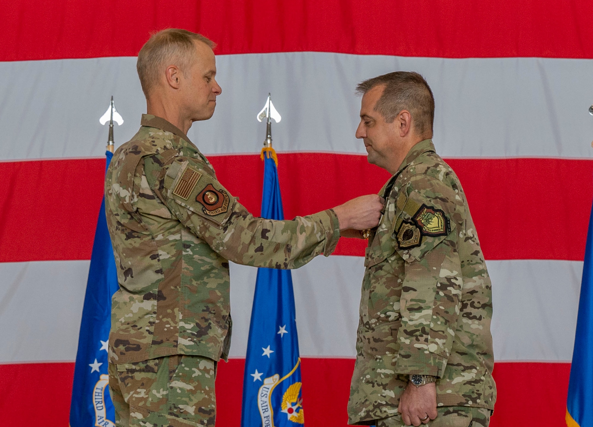 U.S. Air Force Maj. Gen. Derek France, 3rd Air Force commander, pins a meritorious service medal onto Col. Bryan Callahan, 435th Air Ground Operations Wing out-going commander, during the 435th AGOW change of command ceremony at Ramstein Air Base, Germany, June 9, 2023.