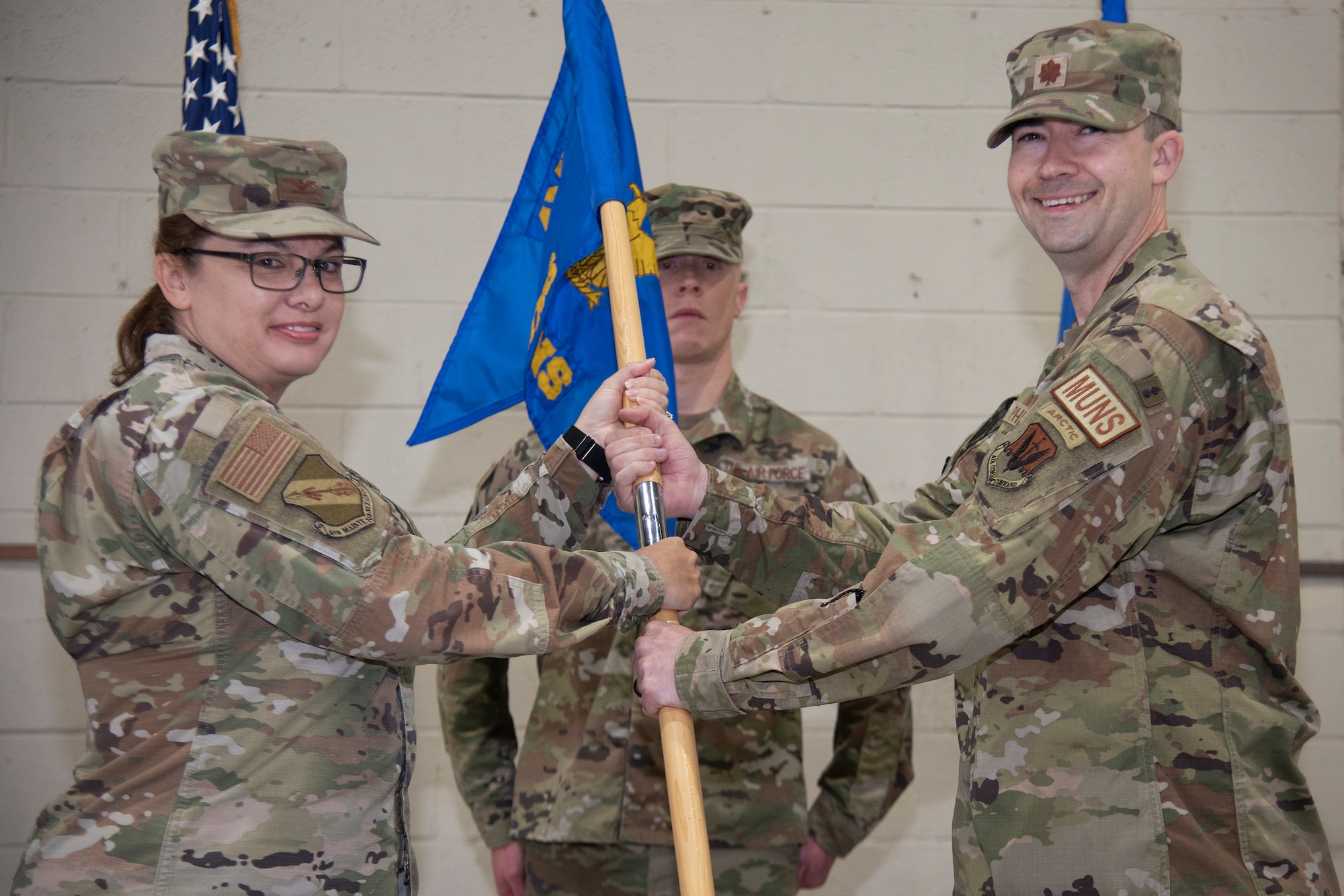 Maj. James Phillips, right, 4th Munitions Squadron incoming commander, assumes command of the 4th MUNS and receives the squadron’s guidon from Col. Kathryn Roman, 4th Maintenance Group commander, during the 4th MUNS change of command ceremony at Seymour Johnson Air Force Base, North Carolina, June 1, 2023. In keeping with tradition, the ceremony gave Lt. Col. Marvin Hinkson, 4th MUNS outgoing commander, a chance to bid his Airmen farewell, and allowed Phillips the opportunity to formally assume command of the squadron, meet the Airmen in his unit, and express his aspirations for the squadron’s future. (U.S. Air Force photo by Tech. Sgt. Christopher Hubenthal)