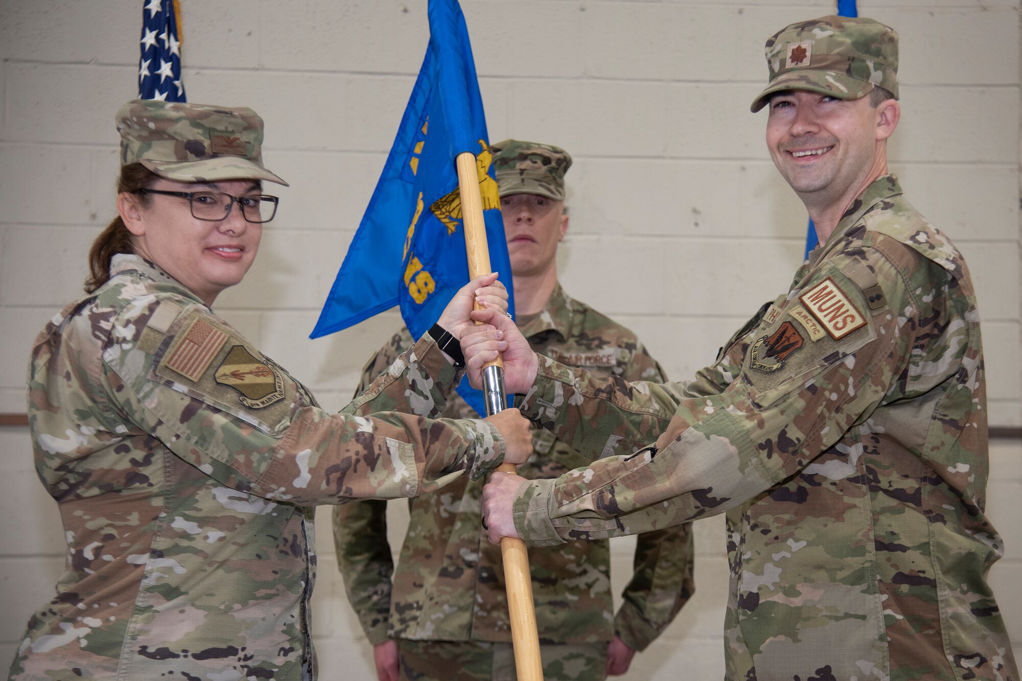 Maj. James Phillips, right, 4th Munitions Squadron incoming commander, assumes command of the 4th MUNS and receives the squadron’s guidon from Col. Kathryn Roman, 4th Maintenance Group commander, during the 4th MUNS change of command ceremony at Seymour Johnson Air Force Base, North Carolina, June 1, 2023. In keeping with tradition, the ceremony gave Lt. Col. Marvin Hinkson, 4th MUNS outgoing commander, a chance to bid his Airmen farewell, and allowed Phillips the opportunity to formally assume command of the squadron, meet the Airmen in his unit, and express his aspirations for the squadron’s future. (U.S. Air Force photo by Tech. Sgt. Christopher Hubenthal)